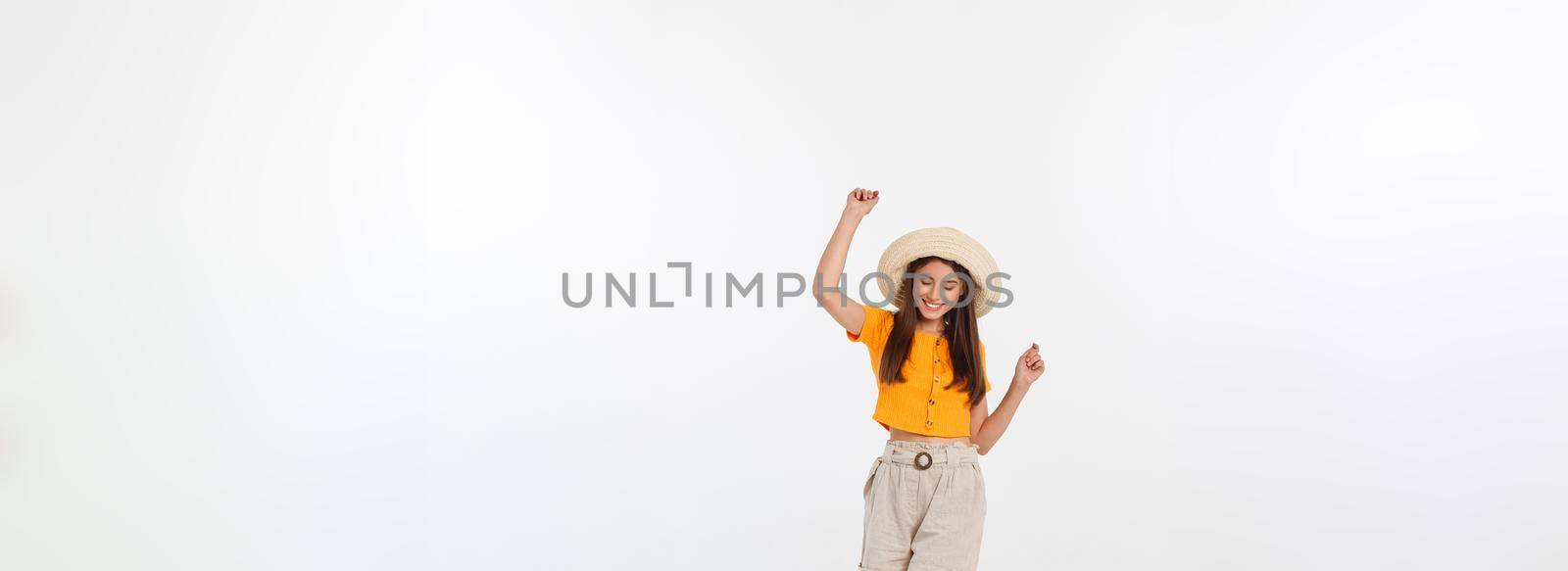Cool hipster portrait of young stylish teen girl showing her hands up, positive mood and emotions,travel alone. Isolated over grey background.