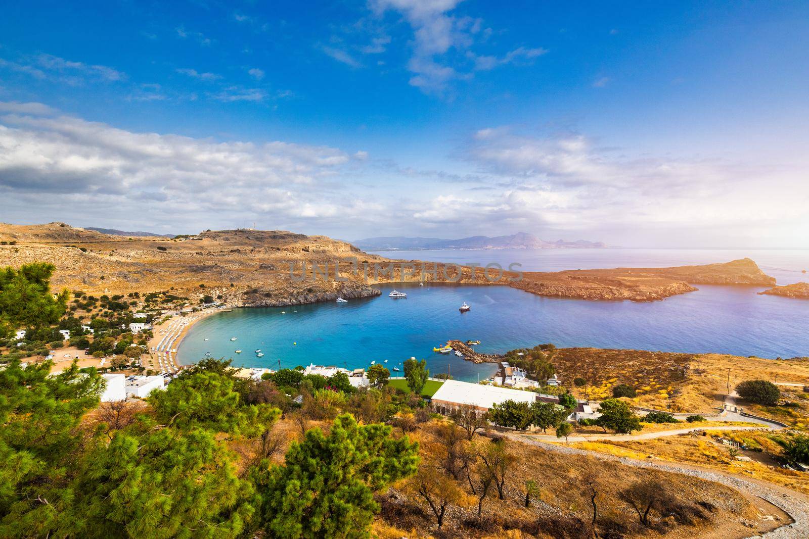 The famous and historical medieval village of Lindos on the Greek island of Rhodes with the Acropolis in the background. Lindos, Rhodes, Greece.