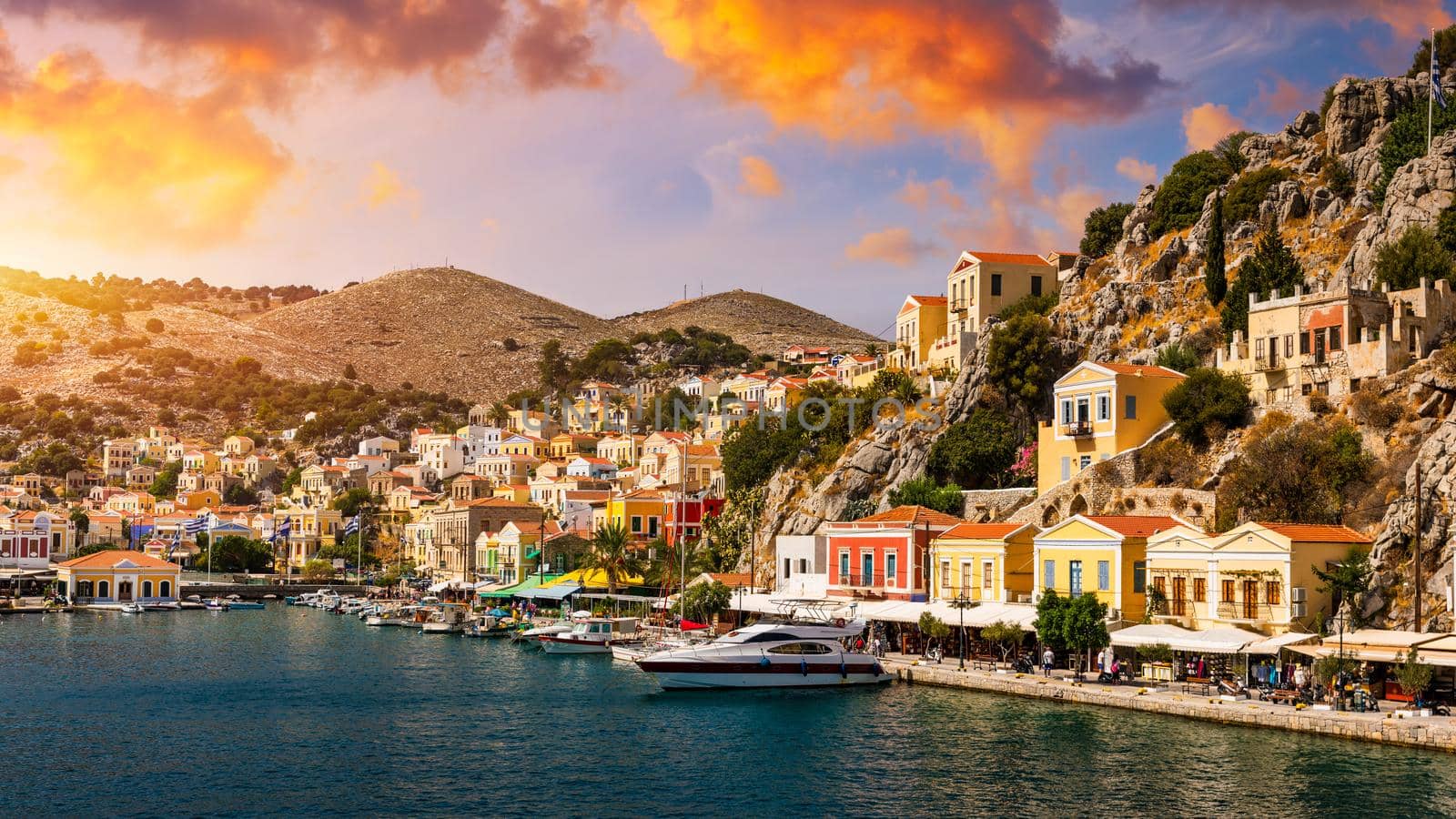 View of the beautiful greek island of Symi (Simi) with colourful houses and small boats. Greece, Symi island, view of the town of Symi (near Rhodes), Dodecanese.