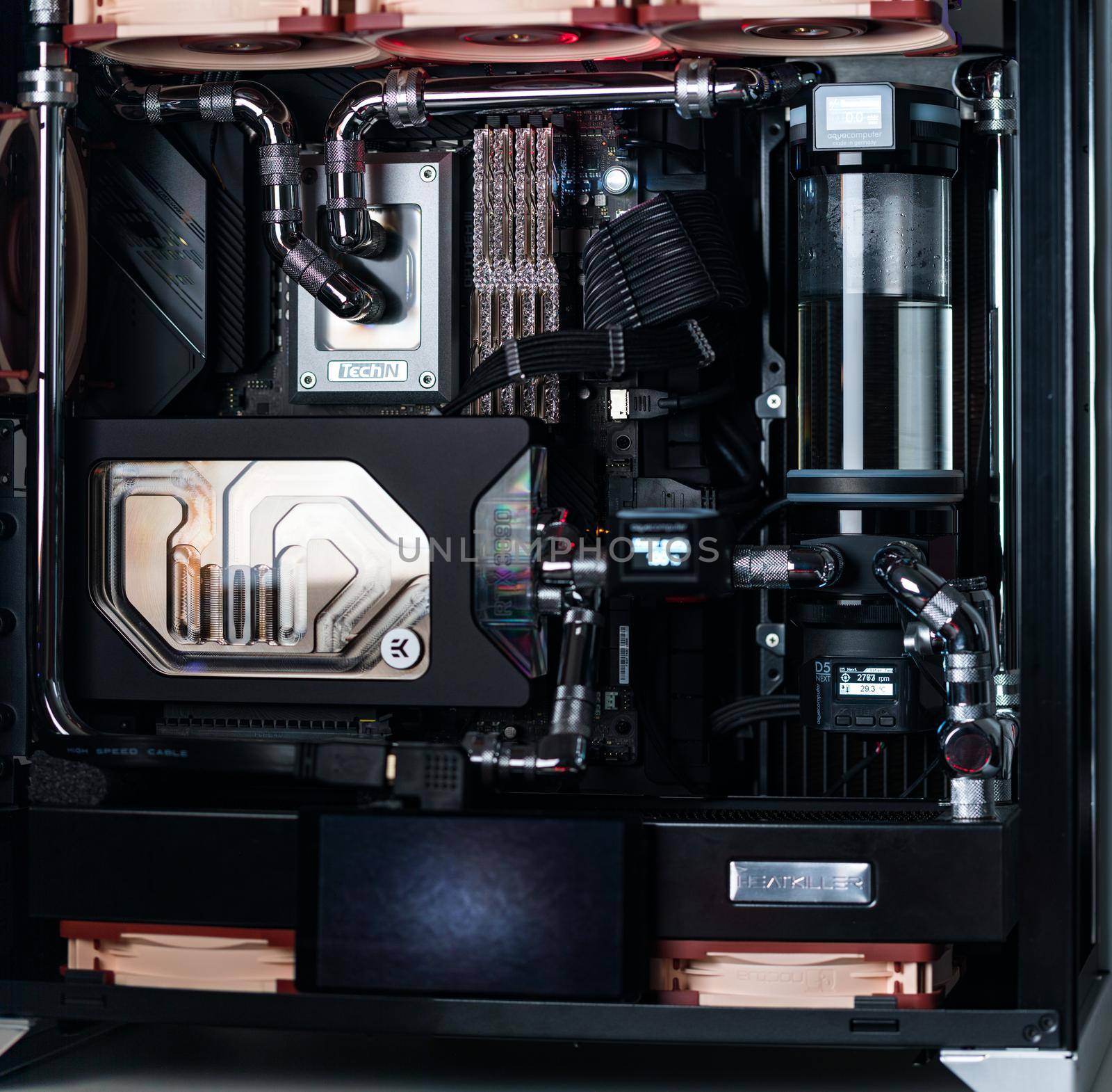 Prague, Czech Republic - 21 July 2021: Close-up of high performance Desktop PC and water cooling system with multicolored LED RGB light show status on working, interior on Computer PC Case and DIY