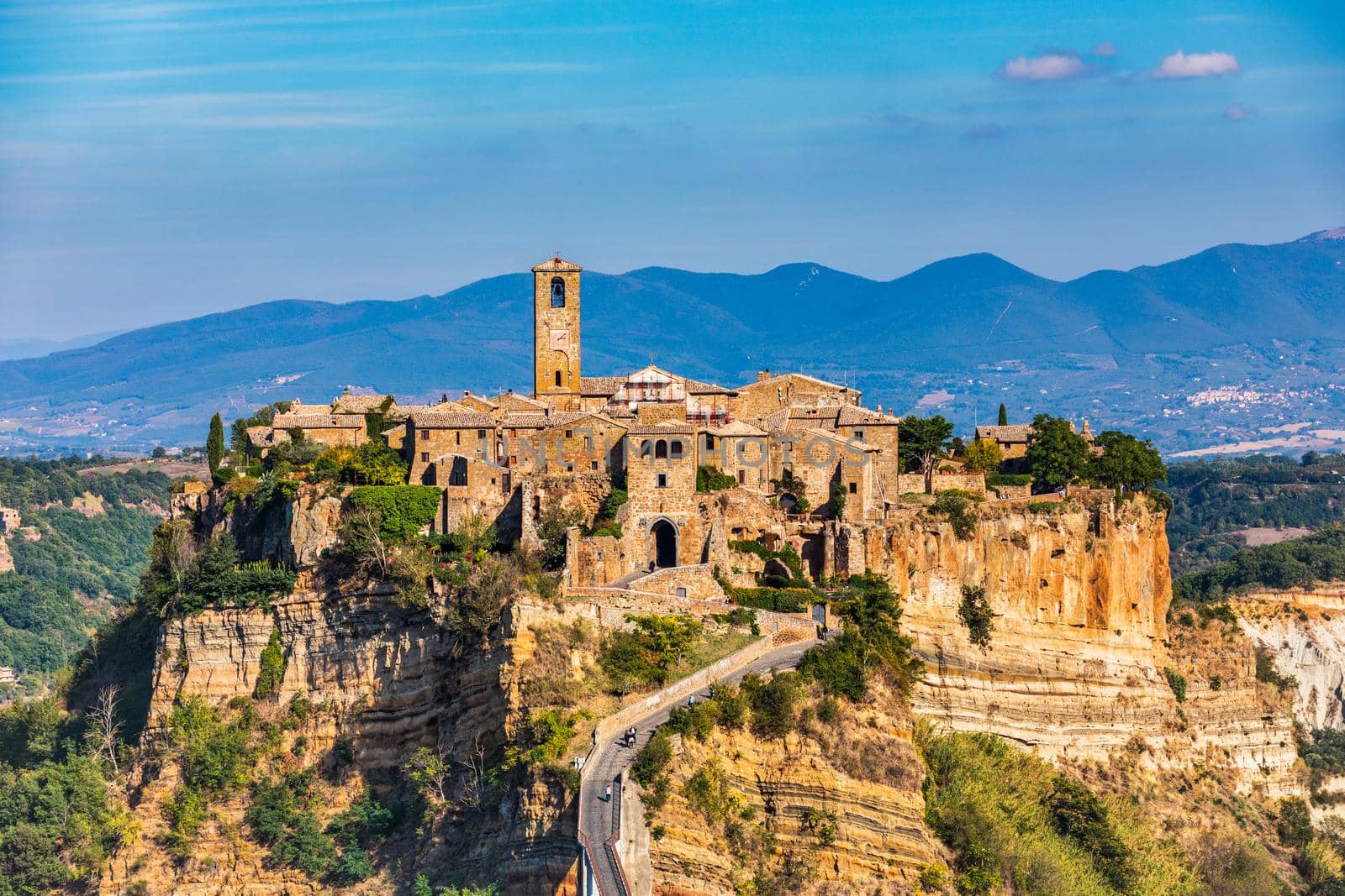 The famous Civita di Bagnoregio on a sunny day. Province of Viterbo, Lazio, Italy. Medieval town on the mountain, Civita di Bagnoregio, popular touristic stop at Tuscany, Italy.