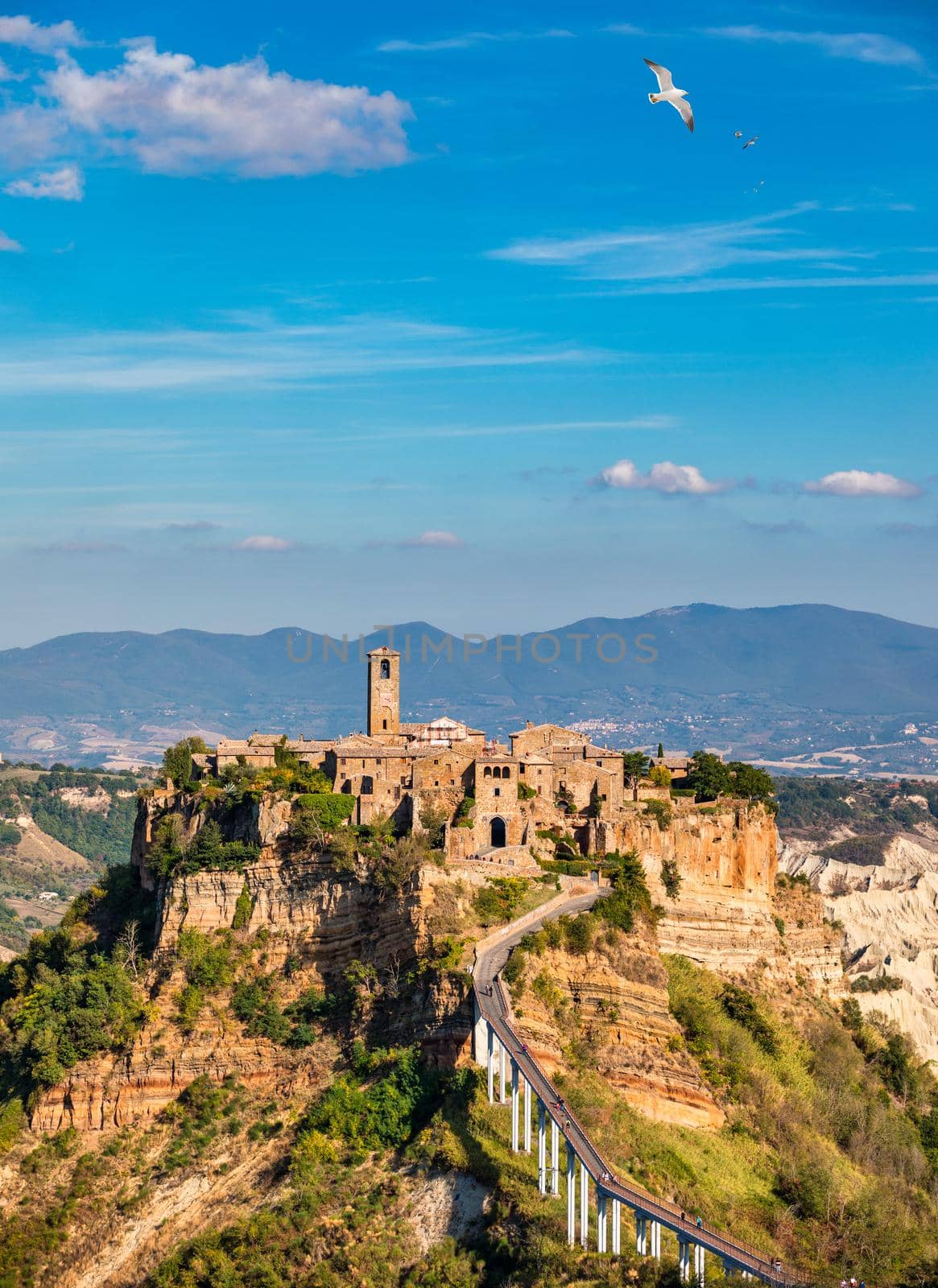 The famous Civita di Bagnoregio on a sunny day. Province of Viterbo, Lazio, Italy. Medieval town on the mountain, Civita di Bagnoregio, popular touristic stop at Tuscany, Italy.