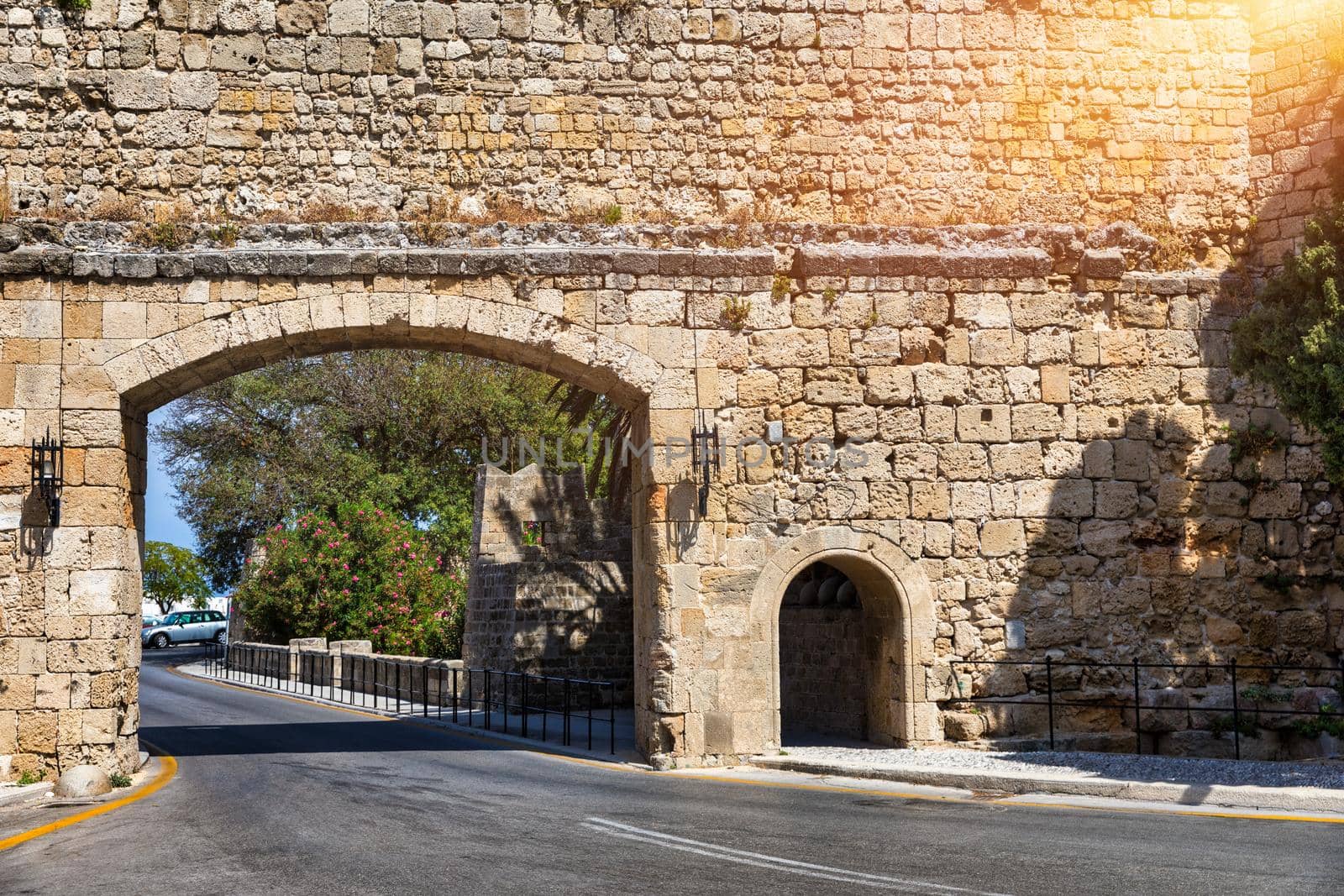 Medieval arched street in the old town of Rhodes, Greece. Rhodes old town in Rhodes island in Greece. Historical streets of old town Rhodes with flowers in Rhodes, Dodecanese, Greece