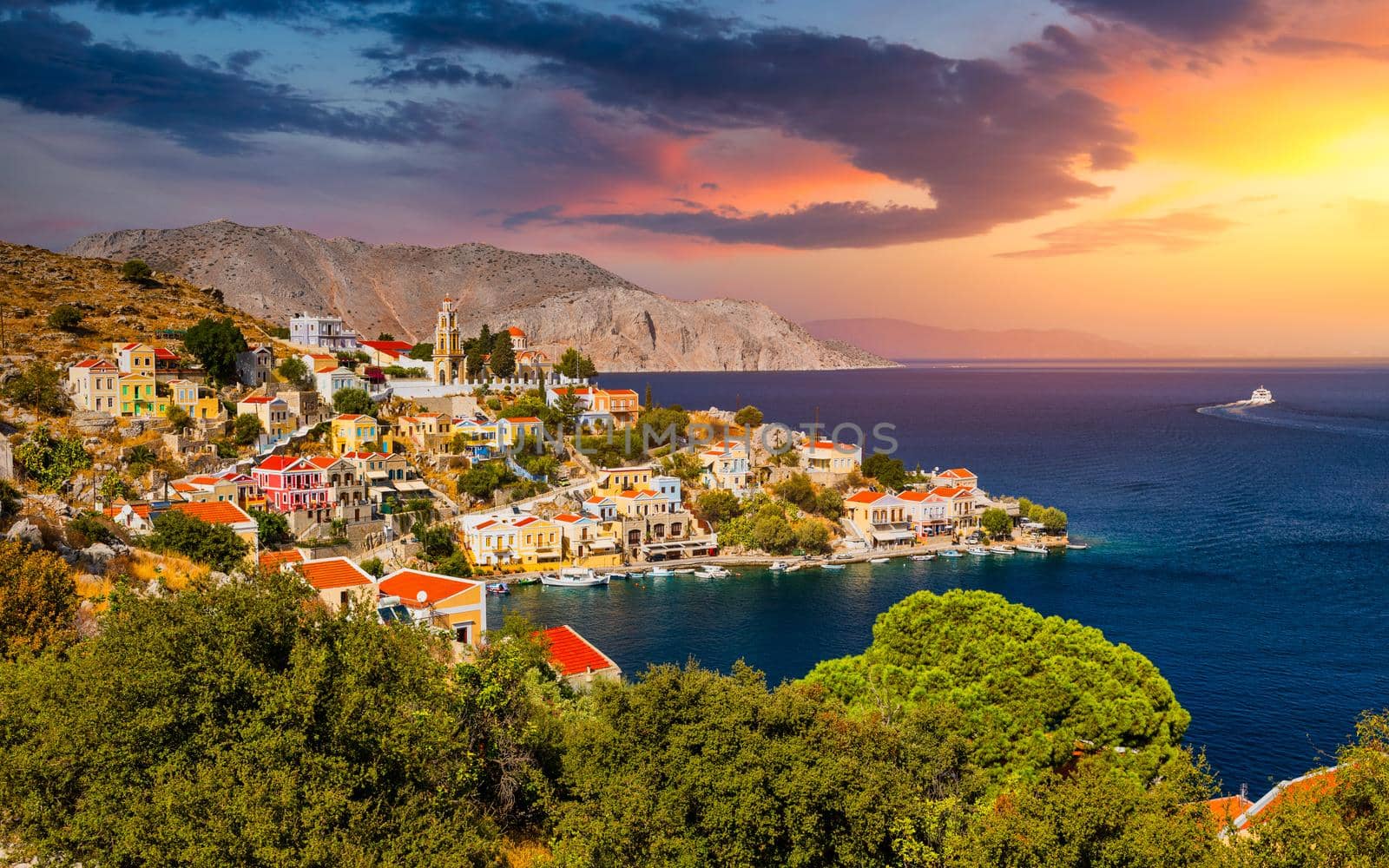 View of the beautiful greek island of Symi (Simi) with colourful houses and small boats. Greece, Symi island, view of the town of Symi (near Rhodes), Dodecanese.
