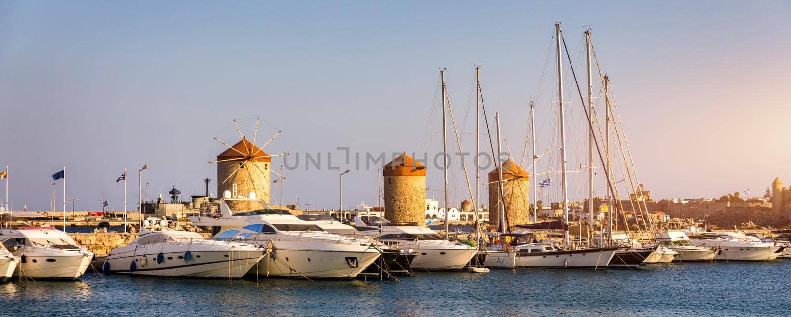 Mandraki port with deers statue, where The Colossus was standing and fort of St. Nicholas. Rhodes, Greece. Hirschkuh statue in the place of the Colossus of Rhodes, Rhodes, Greece