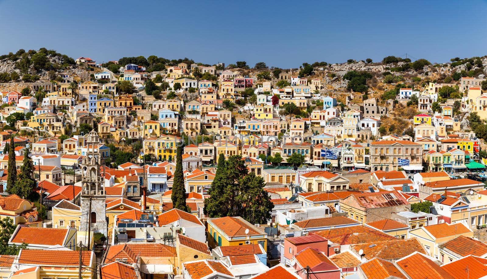 View of the beautiful greek island of Symi (Simi) with colourful houses and small boats. Greece, Symi island, view of the town of Symi (near Rhodes), Dodecanese.