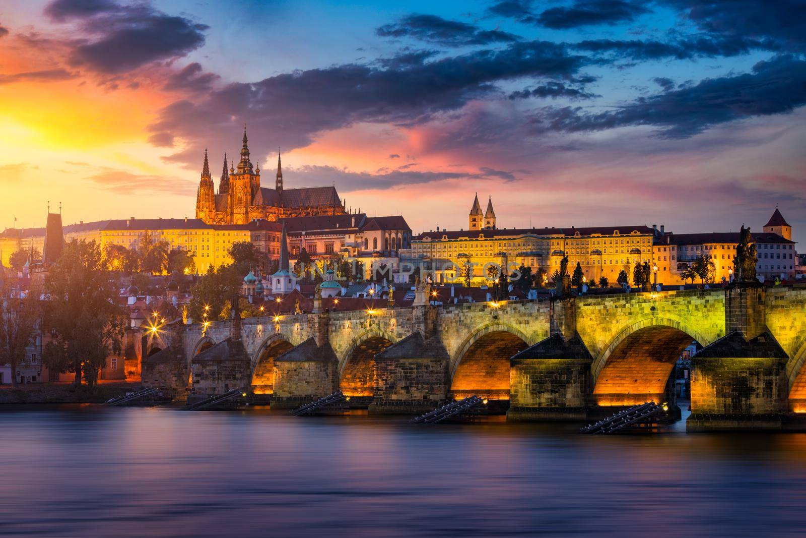 Charles Bridge sunset view of the Old Town pier architecture, Charles Bridge over Vltava river in Prague, Czechia. Old Town of Prague with Charles Bridge and Castle in the background, Czech Republic.