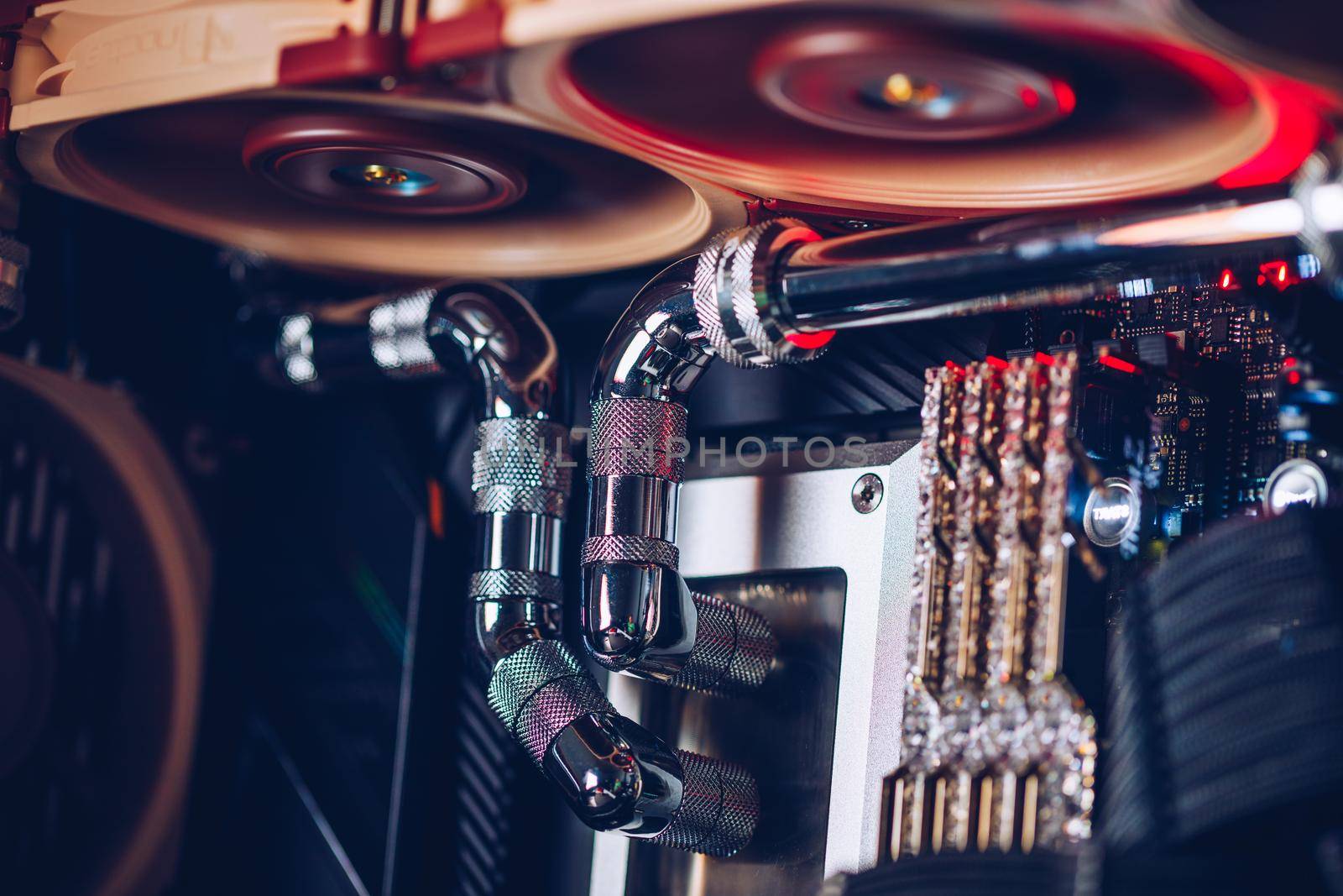 Prague, Czech Republic - 21 July 2021: Close-up of high performance Desktop PC and water cooling system with multicolored LED RGB light show status on working, interior on Computer PC Case and DIY