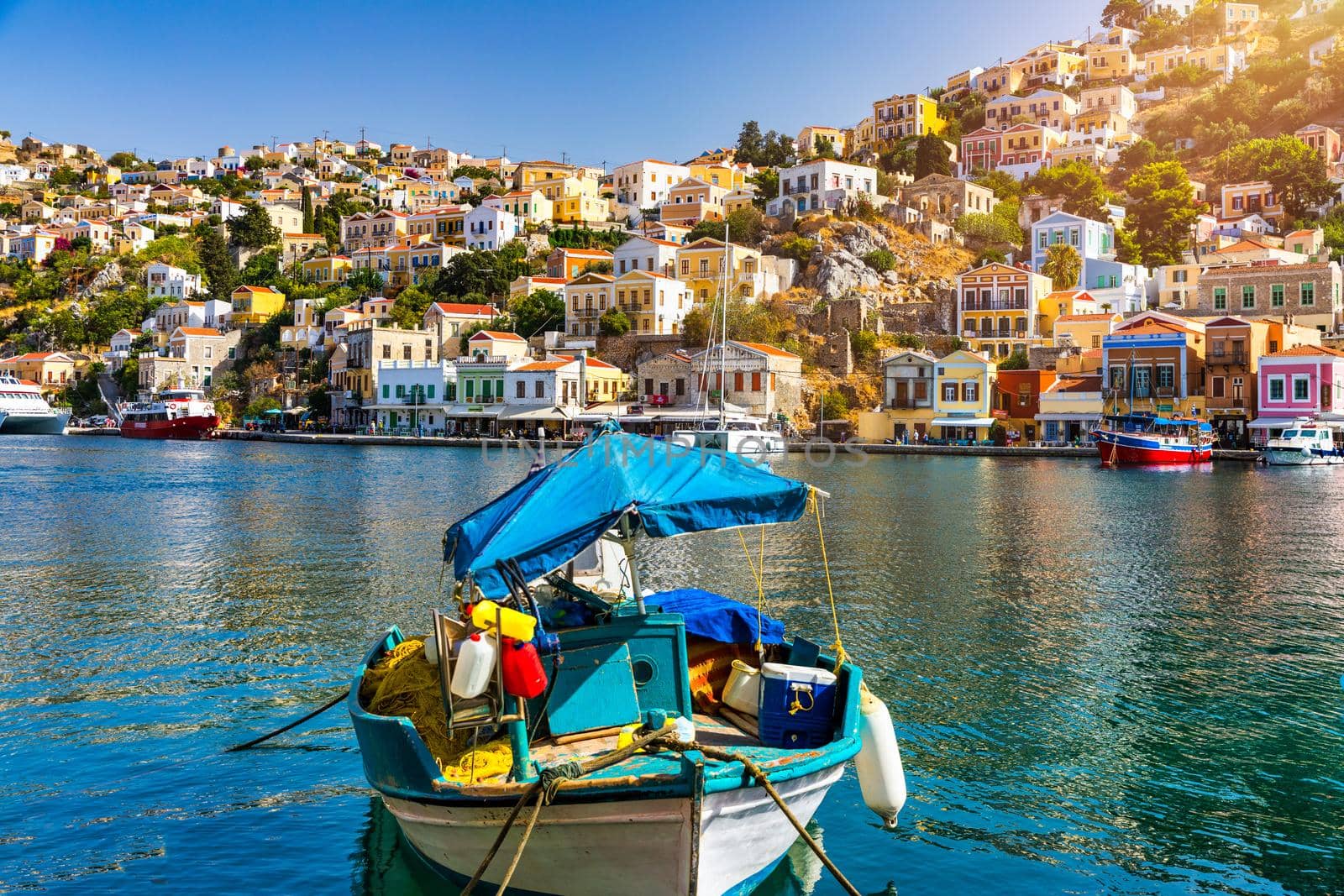 View of the beautiful greek island of Symi (Simi) with colourful houses and small boats. Greece, Symi island, view of the town of Symi (near Rhodes), Dodecanese.