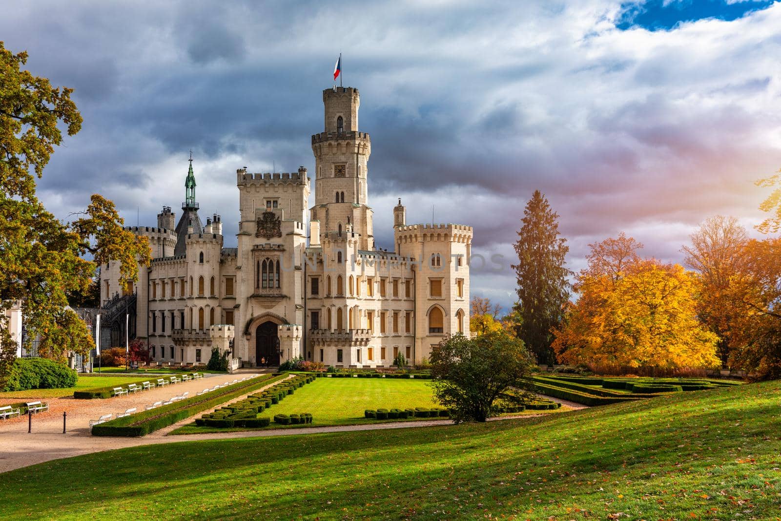Castle Hluboka nad Vltavou is one of the most beautiful castles in Czech Republic. Castle Hluboka nad Vltavou in autumn with red foliage, Czechia. Colorful autumn view of Hluboka nad Vltavou castle.