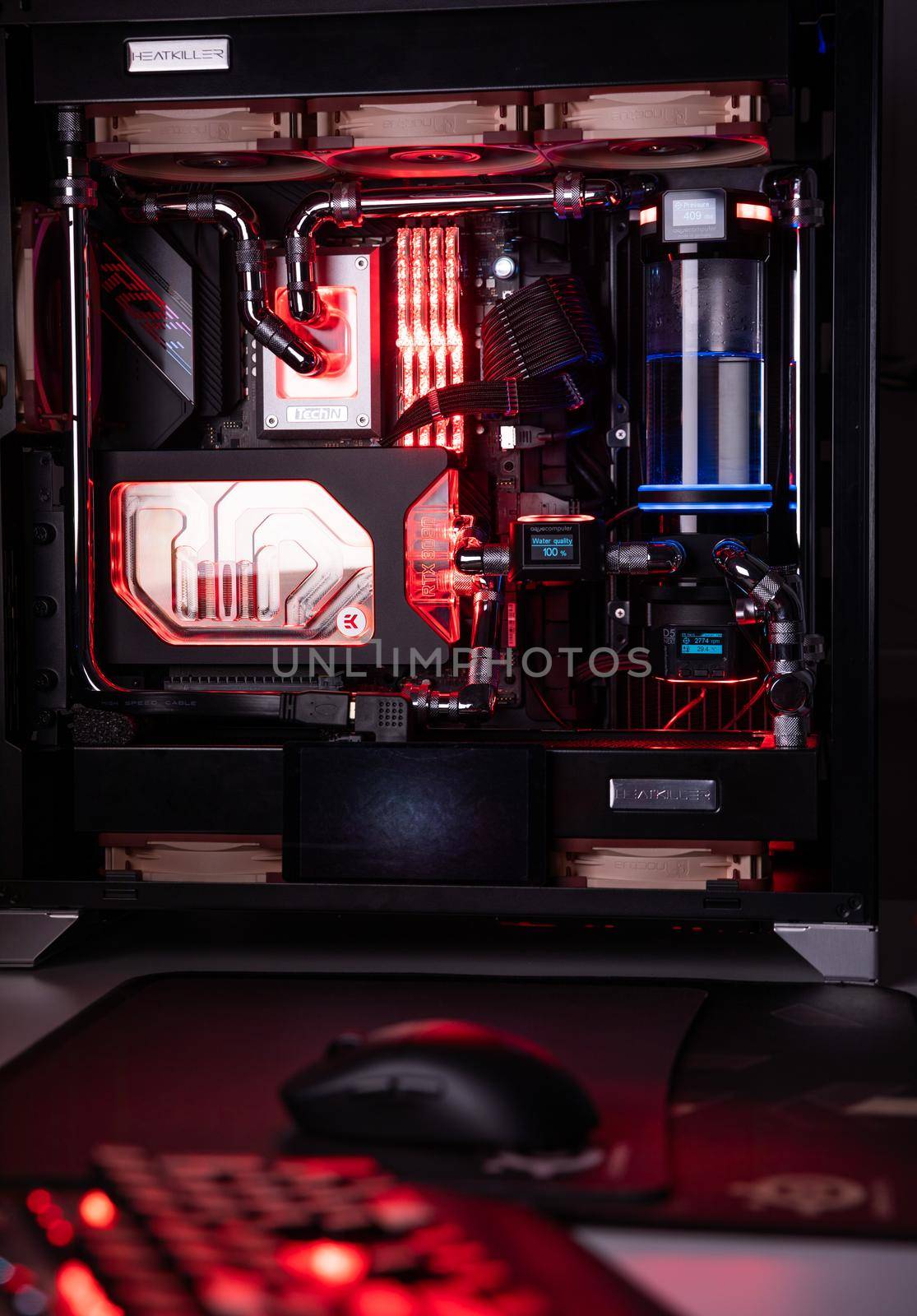 Prague, Czech Republic - 21 July 2021: Close-up of high performance Desktop PC and water cooling system with multicolored LED RGB light show status on working, interior on Computer PC Case and DIY