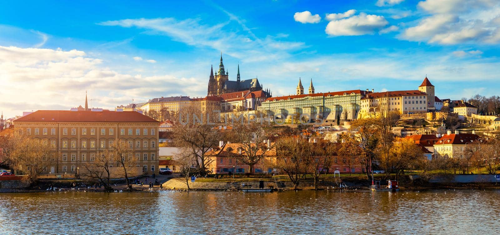 Prague Castle, Charles Bridge and boats on the Vltava river. View of Hradcany Prague Castle, Charles Bridge and a boats on the Vltava river in the capital of the Czechia. 