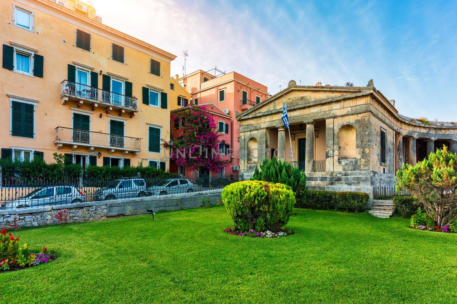 Street view of Kerkyra, capital of Corfu island, Greece. View of Kerkyra with beautiful buildings during summer sunny day. Corfu island, Greece. 