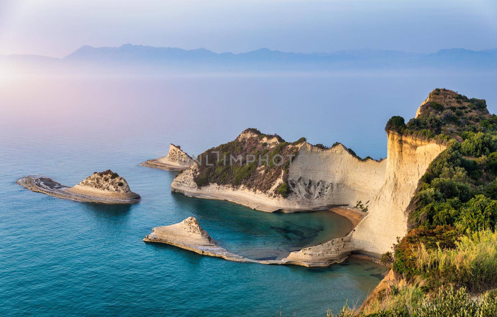 Beautiful view of Cape Drastis in the island of Corfu in Greece. Cape Drastis, the impressive formations of the ground, rocks and the blue waters panorama, Cape Drastis, Corfu, Greece, Ionian Islands.