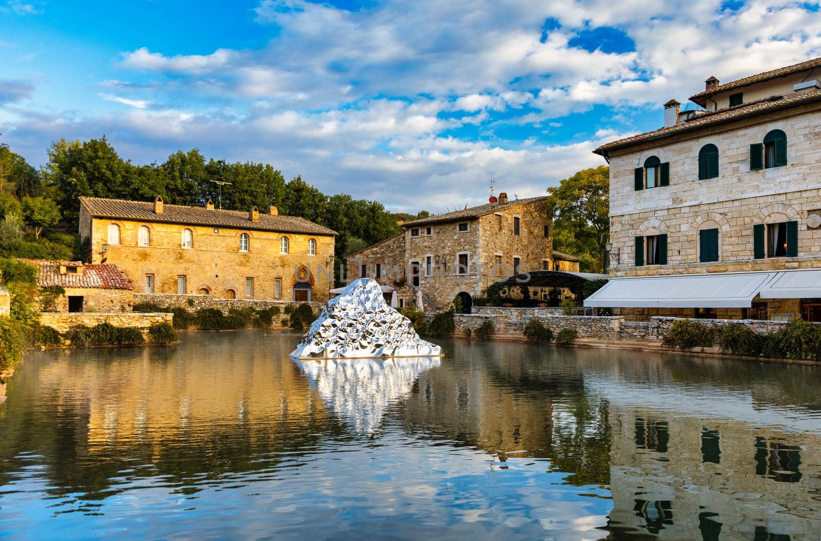 Thermal bath town of Bagno Vignoni, Italy during sunrise. Old thermal baths in the medieval village Bagno Vignoni, Tuscany, Italy. Medieval thermal baths in village Bagno Vignoni, Tuscany, Italy 
