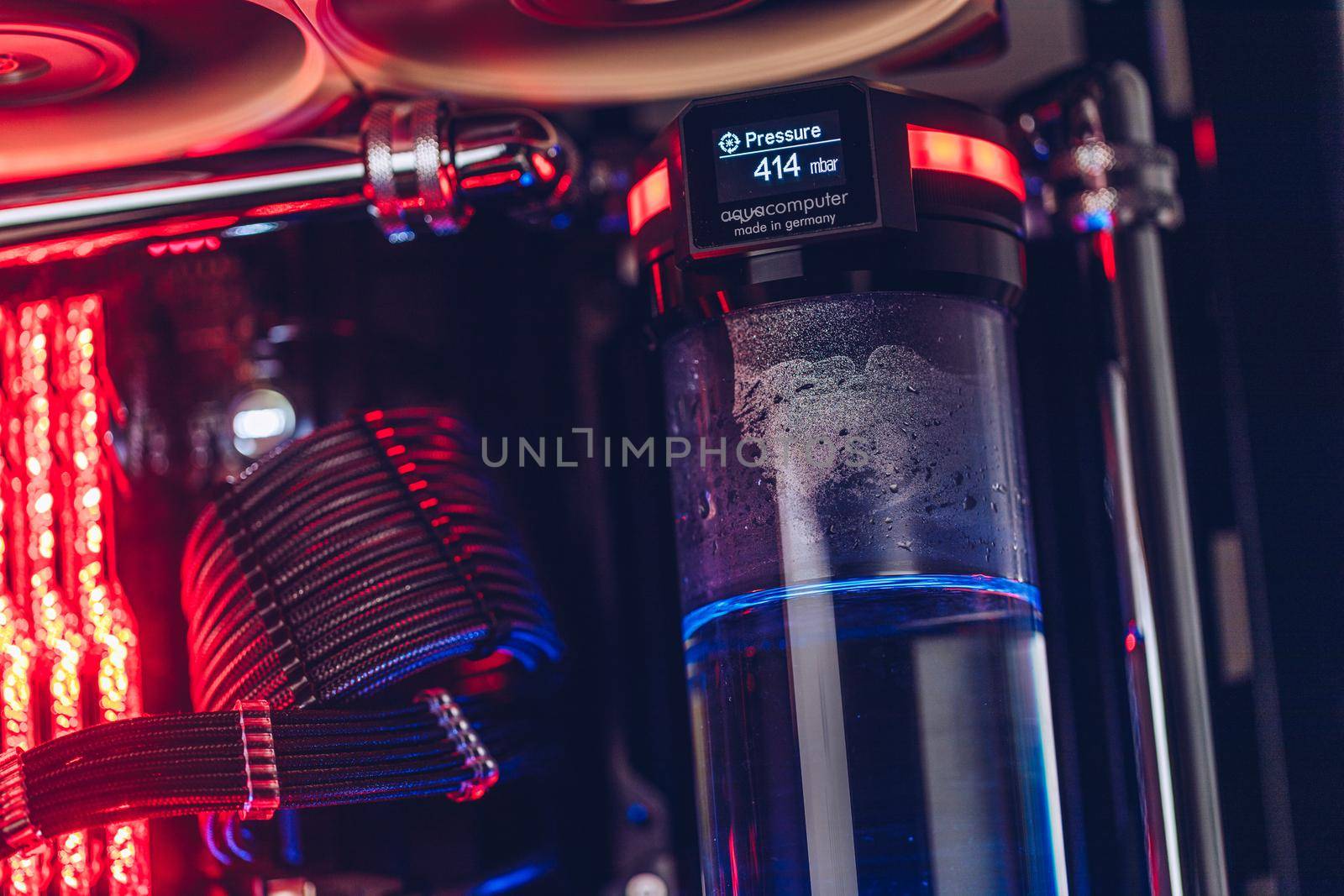 Prague, Czech Republic - 21 July 2021: Close-up of high performance Desktop PC and water cooling system with multicolored LED RGB light show status on working, interior on Computer PC Case and DIY
