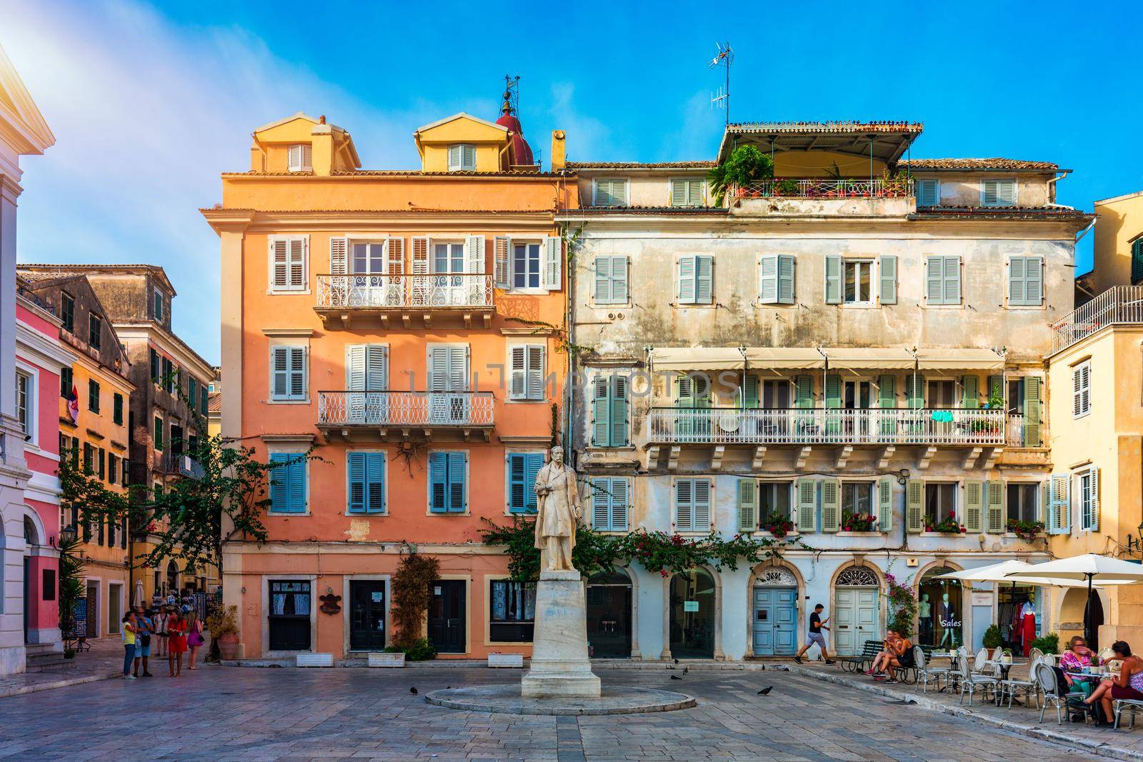 Street view of Kerkyra, capital of Corfu island, Greece. View of Kerkyra with beautiful buildings during summer sunny day. Corfu island, Greece. 