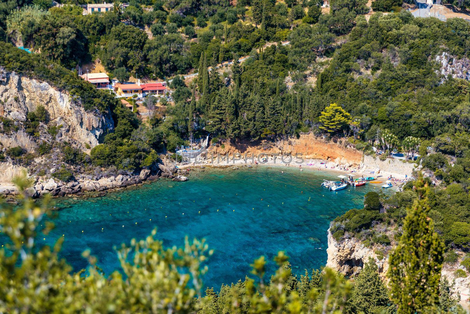Picturesque seaside of Paleokastritsa, Corfu, Greece. Beautiful bay in Paleokastritsa in Corfu island, Greece. Panoramic view of Palaiokastritsa, boats and beach Corfu, Greece