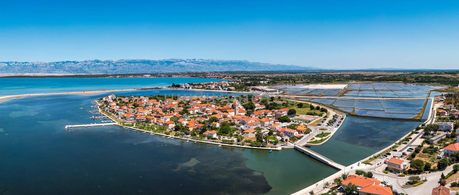 Historic town of Nin laguna aerial view with Velebit mountain background, Dalmatia region of Croatia. Aerial view of the famous Nin lagoon and medieval in Croatia