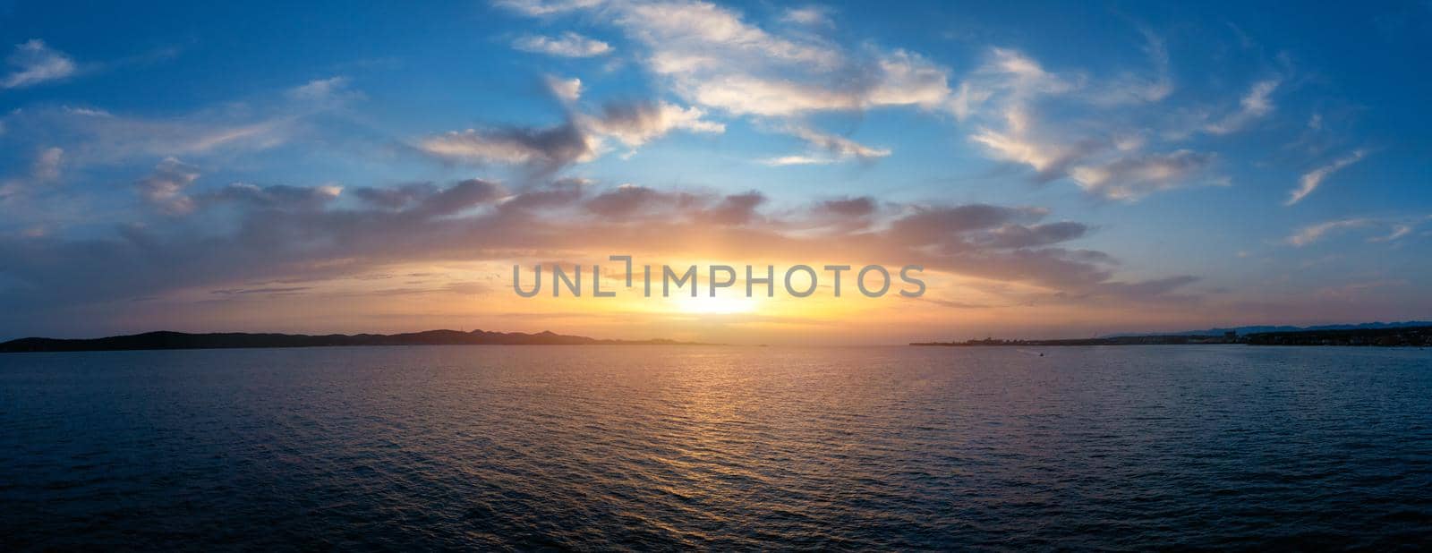 Drone flying over sea in a beautiful sunset in Adriatic sea. Aerial drone shoot. Sunrise over the sea. Colorful sunset on the Adriatic Sea, Croatia.