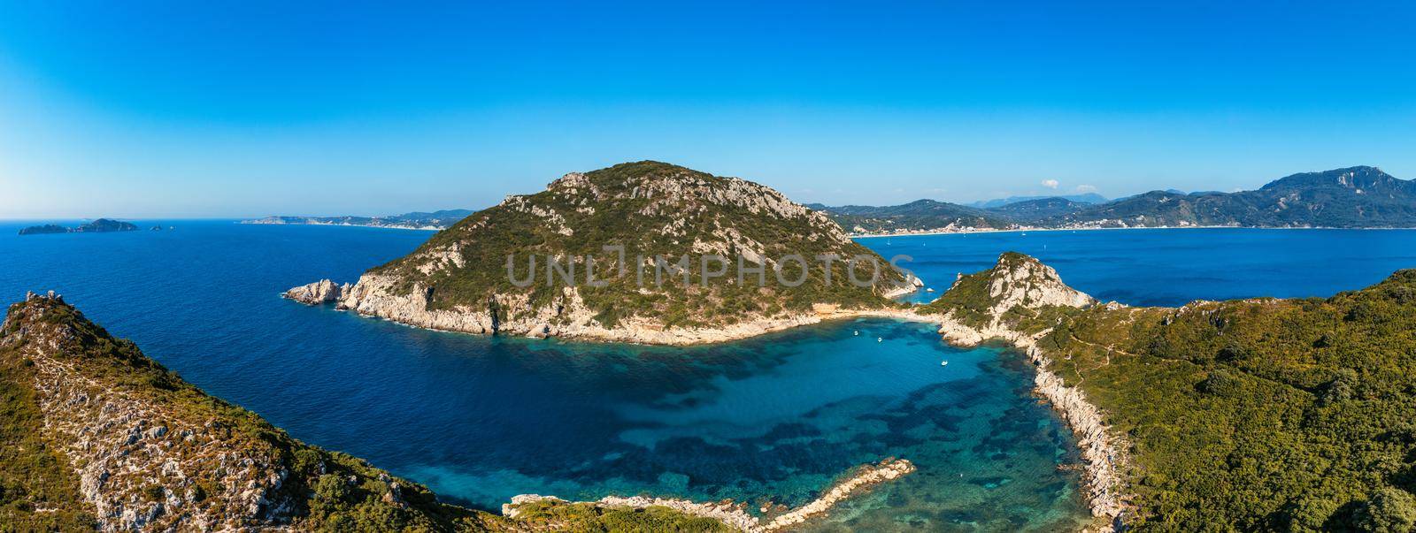 Porto Timoni is an amazing beautiful double beach in Corfu, Greece. Porto Timoni beach at Afionas is a paradise double beach with crystal clear azure water in Corfu, Ionian island, Greece, Europe