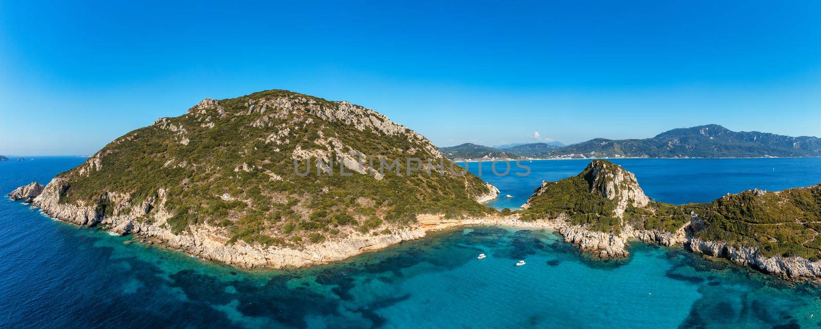 Porto Timoni is an amazing beautiful double beach in Corfu, Greece. Porto Timoni beach at Afionas is a paradise double beach with crystal clear azure water in Corfu, Ionian island, Greece, Europe