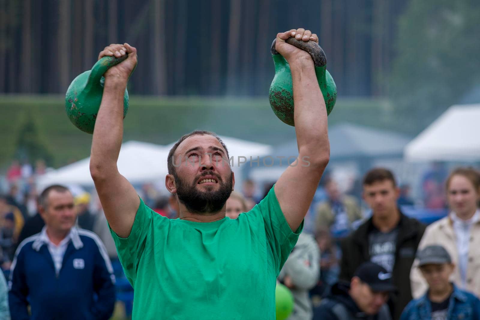 A man lifts a kettlebell sports equipment. Bashkortostan, Russia - 19 June, 2022. by Essffes