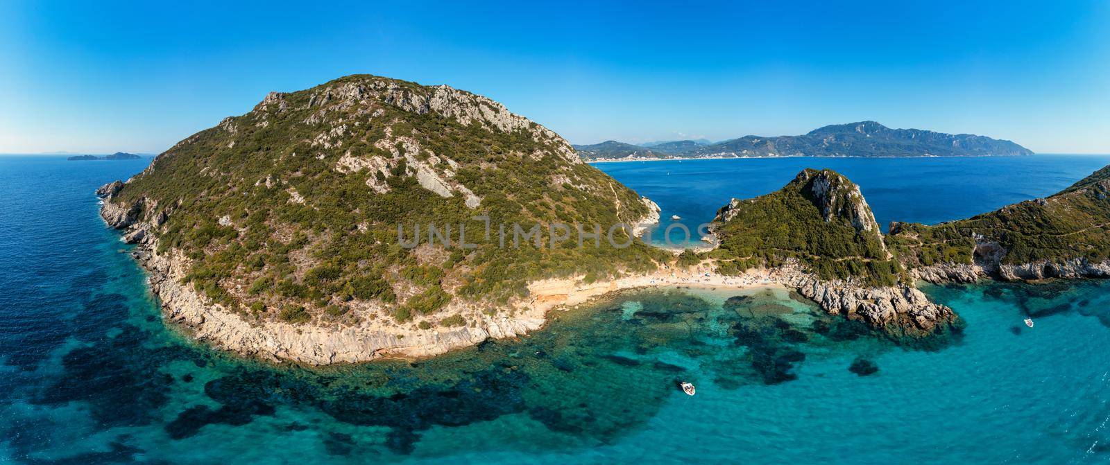 Porto Timoni is an amazing beautiful double beach in Corfu, Greece. Porto Timoni beach at Afionas is a paradise double beach with crystal clear azure water in Corfu, Ionian island, Greece, Europe