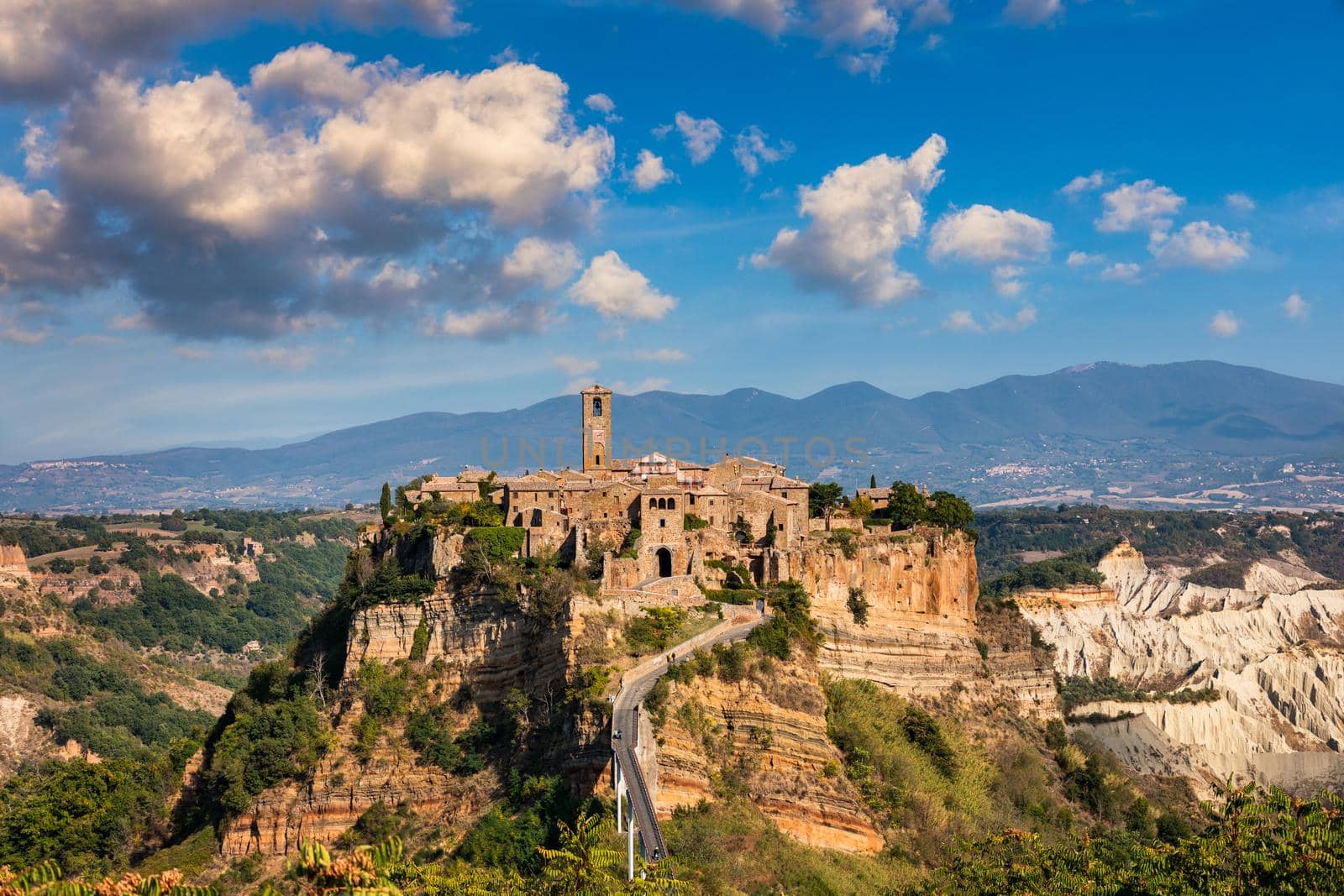 The famous Civita di Bagnoregio on a sunny day. Province of Viterbo, Lazio, Italy. Medieval town on the mountain, Civita di Bagnoregio, popular touristic stop at Tuscany, Italy.