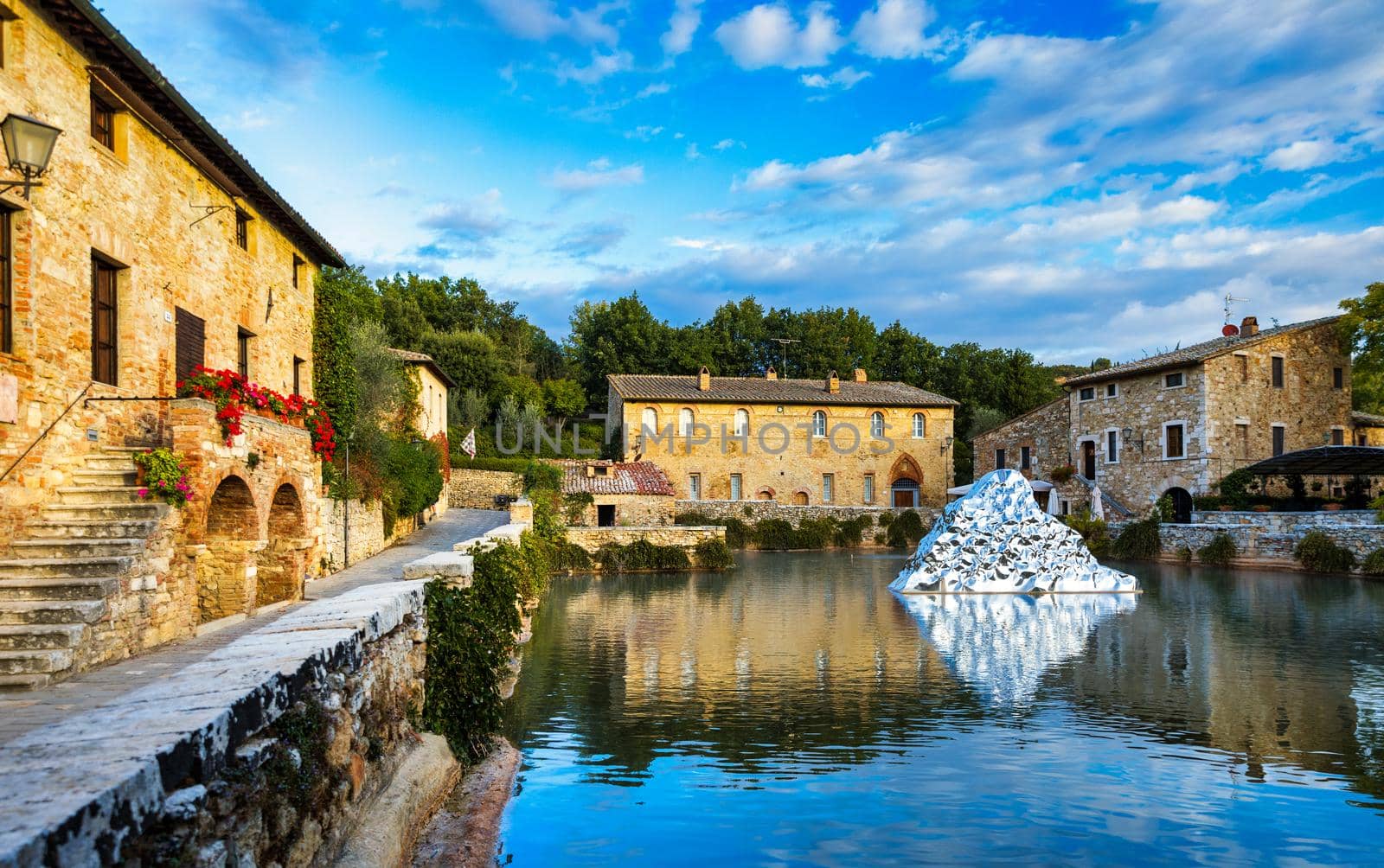 Thermal bath town of Bagno Vignoni, Italy during sunrise. Old thermal baths in the medieval village Bagno Vignoni, Tuscany, Italy. Medieval thermal baths in village Bagno Vignoni, Tuscany, Italy 