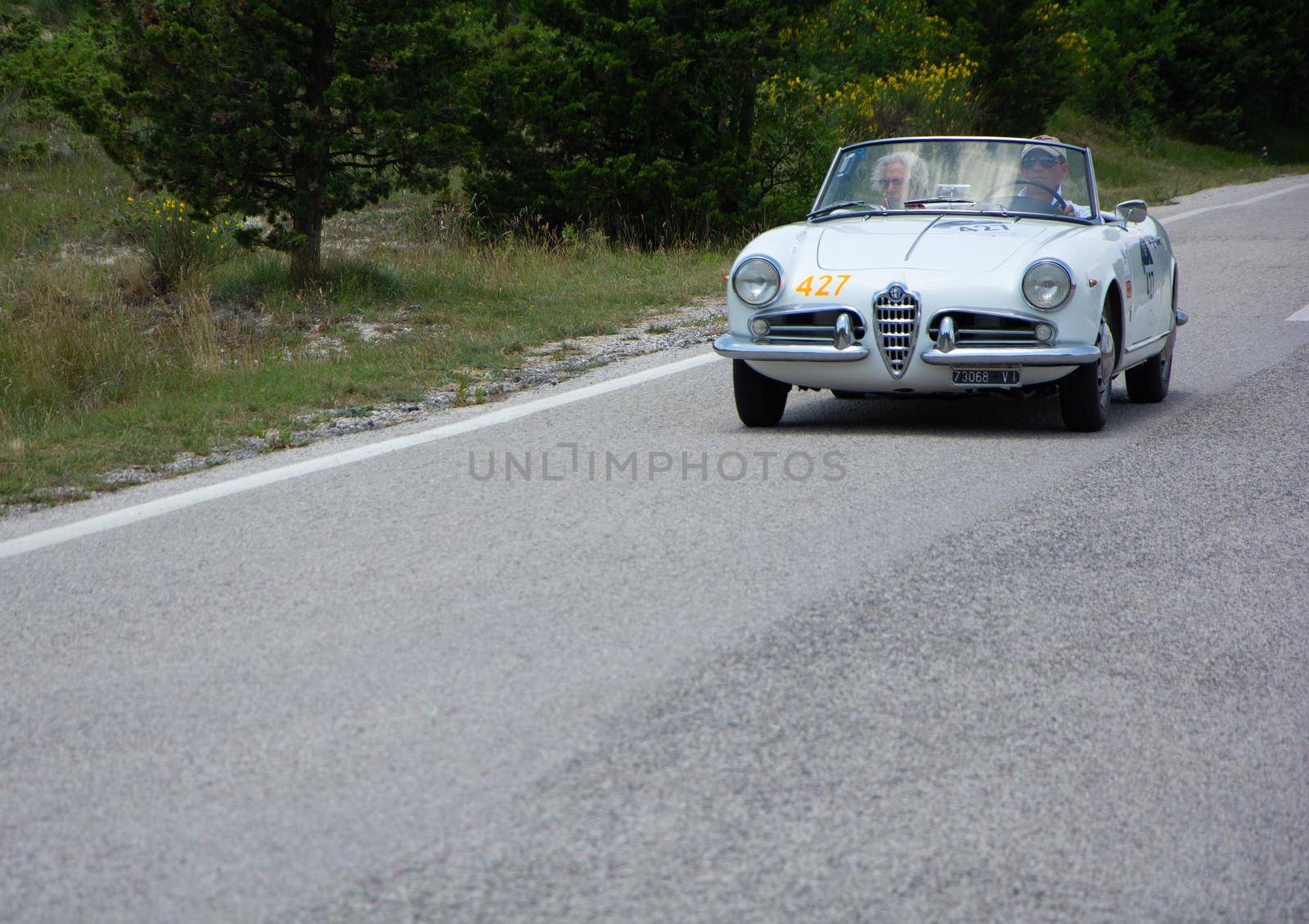 ALFA ROMEO GIULIETTA SPIDER 1957 on an old racing car in rally Mille Miglia 2022 the famous italian historical race (1927-1957 by massimocampanari