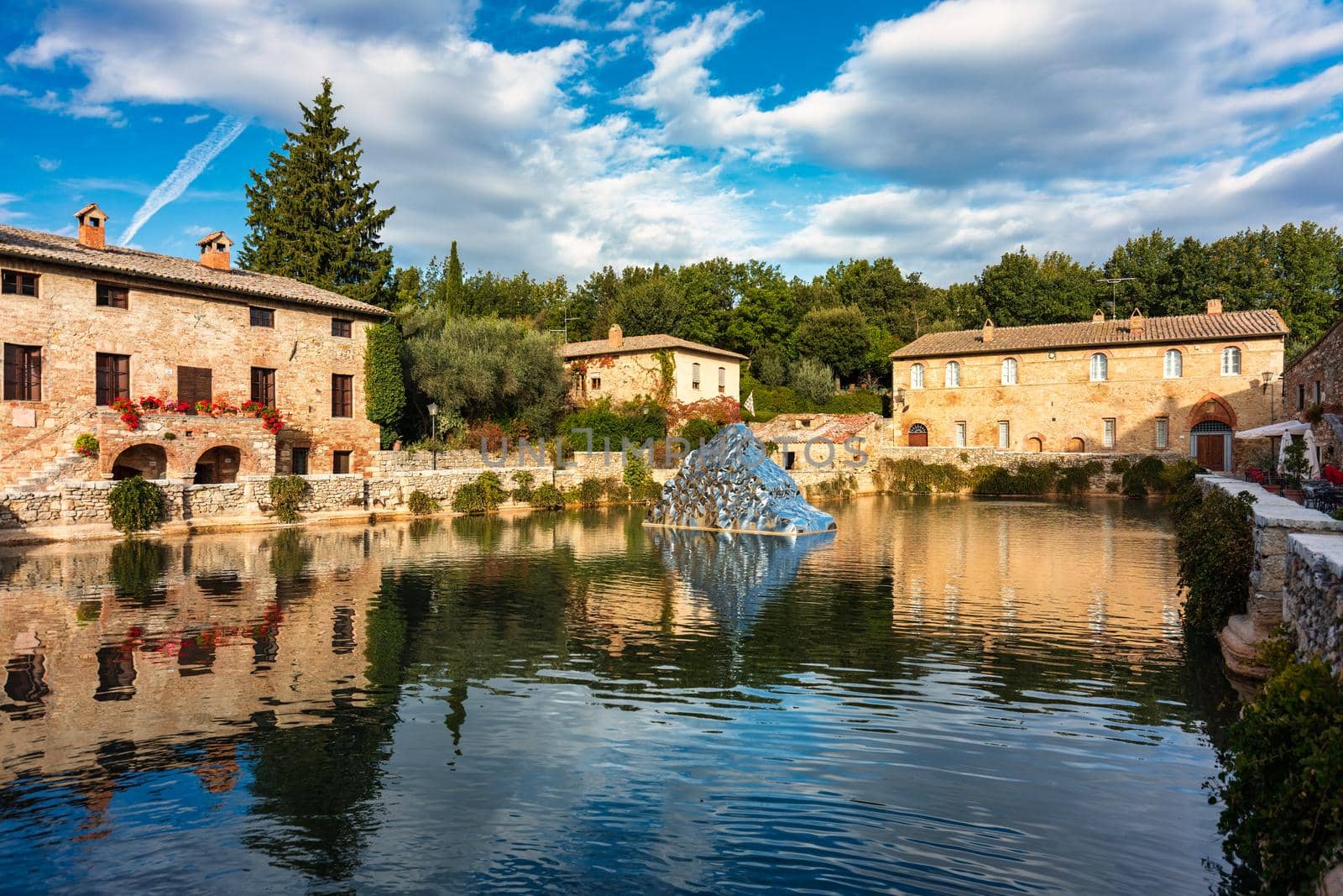 Thermal bath town of Bagno Vignoni, Italy during sunrise. Old thermal baths in the medieval village Bagno Vignoni, Tuscany, Italy. Medieval thermal baths in village Bagno Vignoni, Tuscany, Italy 