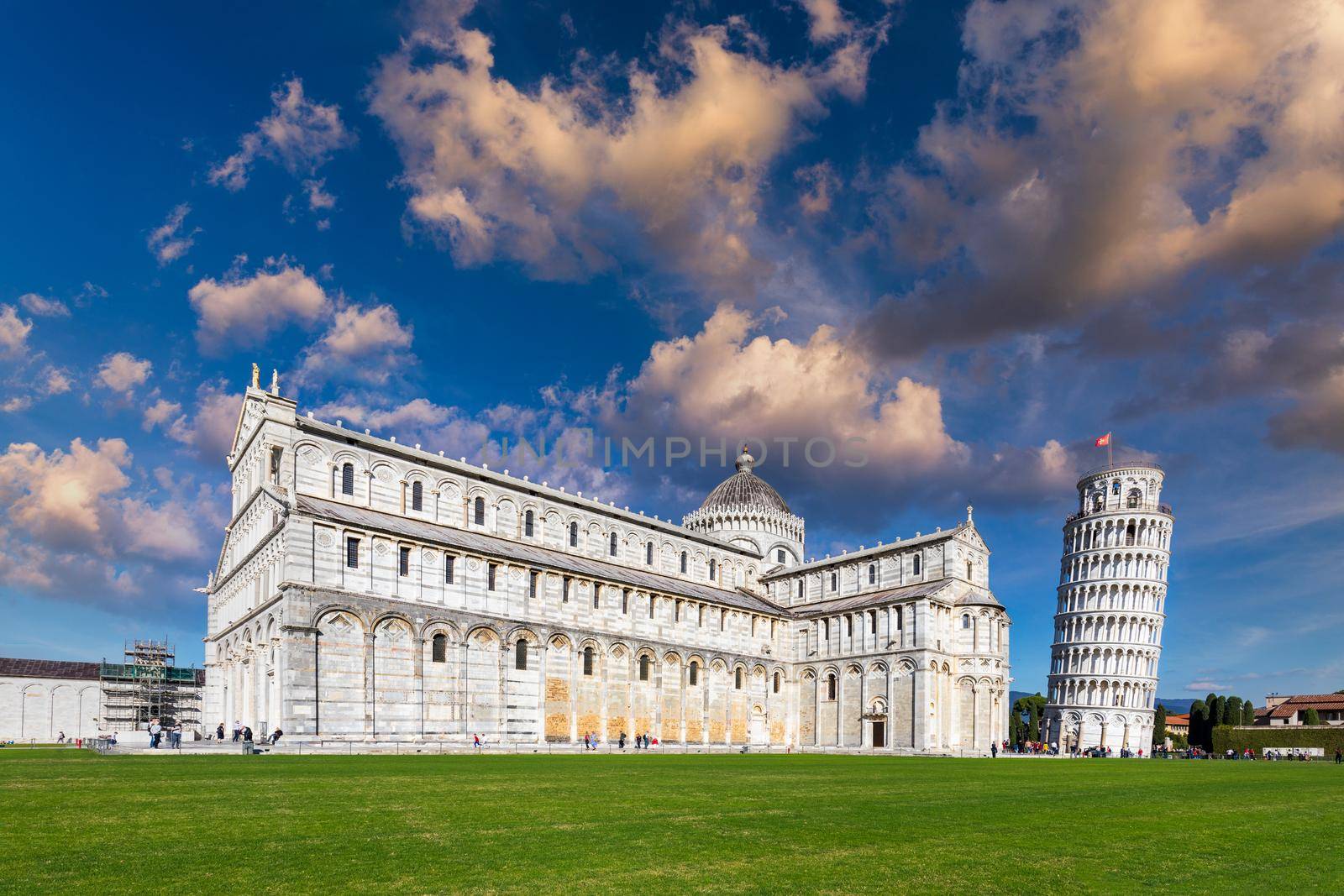 Pisa Cathedral and the Leaning Tower in a sunny day in Pisa, Italy. Pisa Cathedral with Leaning Tower of Pisa on Piazza dei Miracoli in Pisa, Tuscany, Italy.