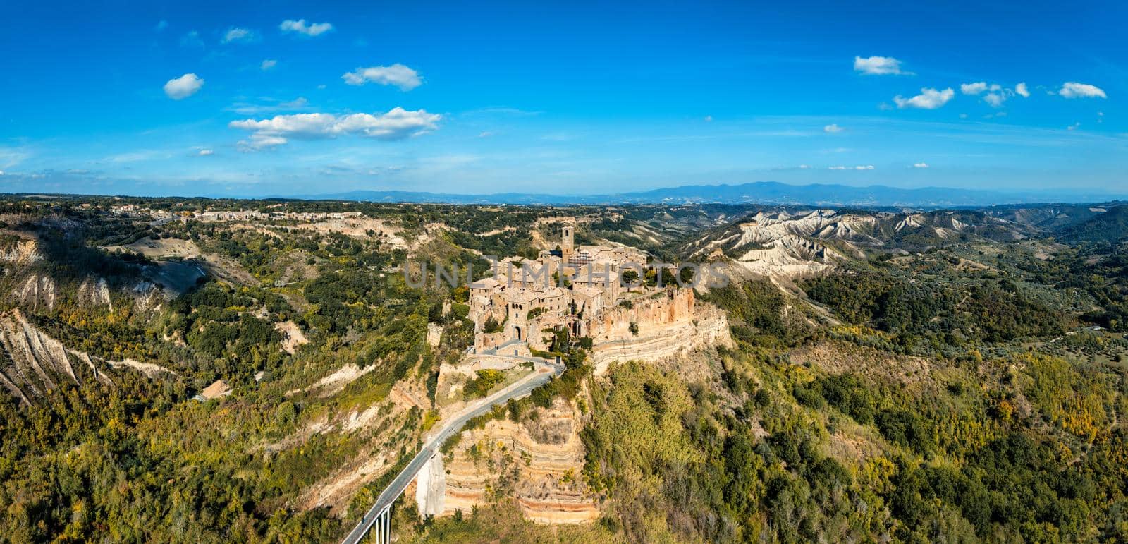 The famous Civita di Bagnoregio on a sunny day. Province of Viterbo, Lazio, Italy. Medieval town on the mountain, Civita di Bagnoregio, popular touristic stop at Tuscany, Italy.