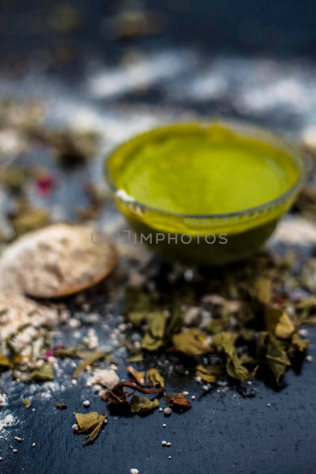 Neem or Indian Lilac face mask on the black wooden surface for acne and scars consisting of gram flour, neem paste, and some curd. by mirzamlk