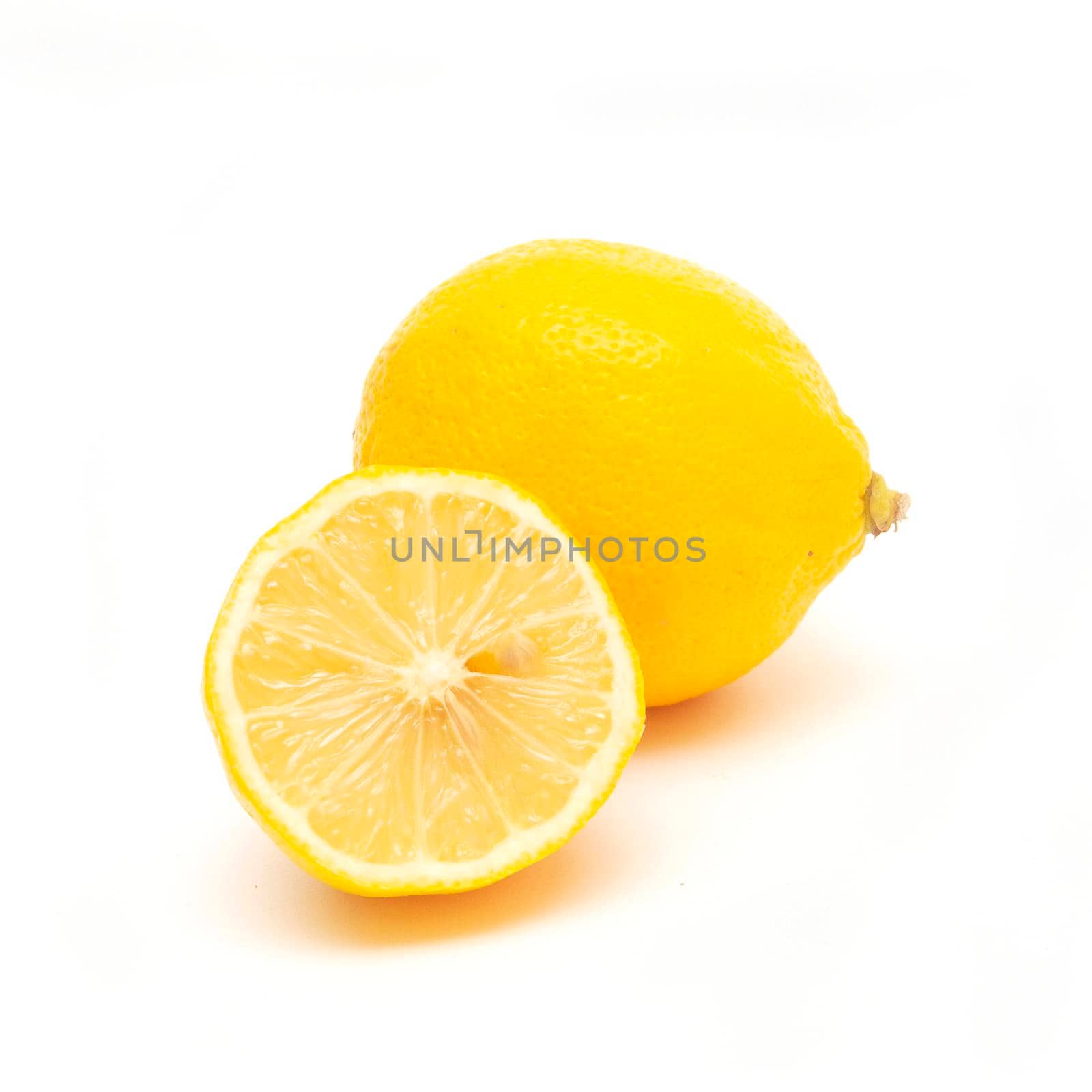 fresh lemon fruit and a half of lemon isolated on white. by andre_dechapelle