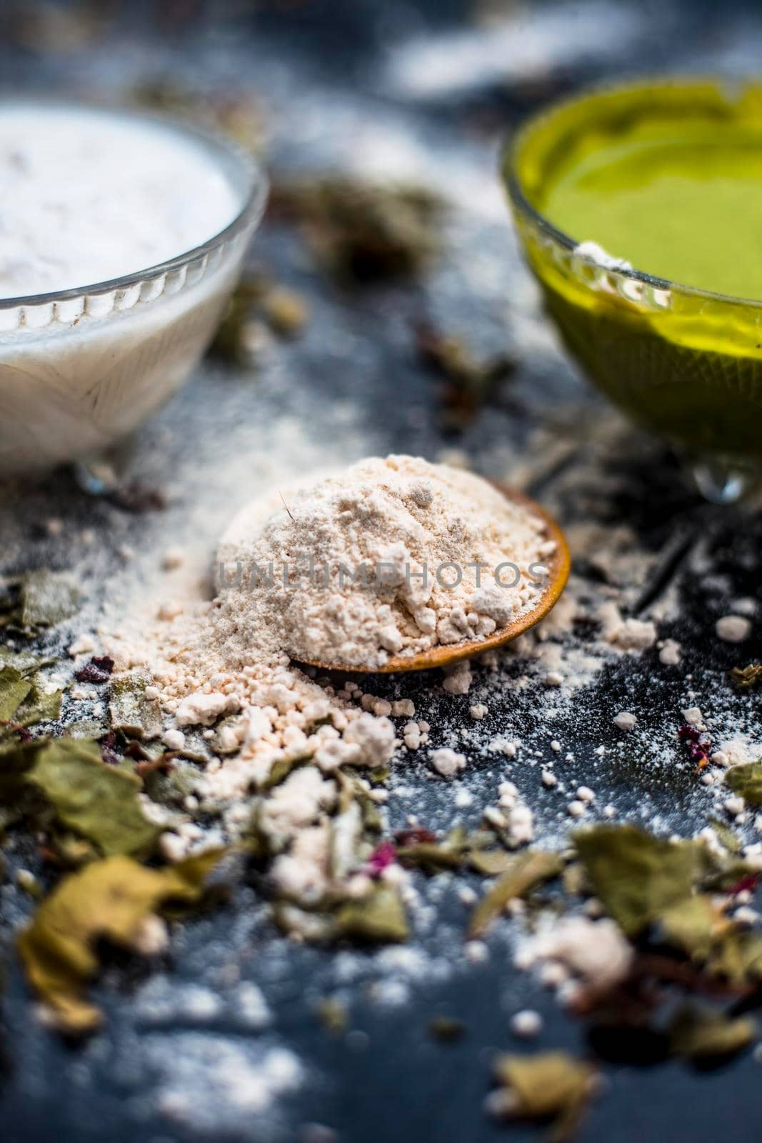Neem or Indian Lilac face mask on the black wooden surface for acne and scars consisting of gram flour, neem paste, and some curd. by mirzamlk