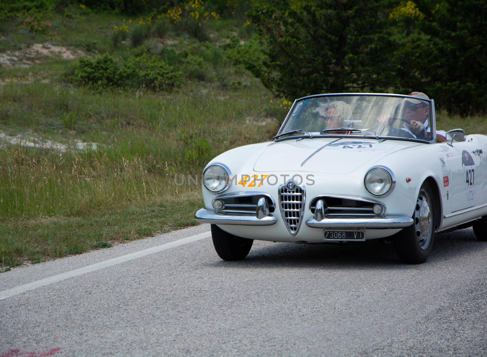 ALFA ROMEO GIULIETTA SPIDER 1957 on an old racing car in rally Mille Miglia 2022 the famous italian historical race (1927-1957 by massimocampanari