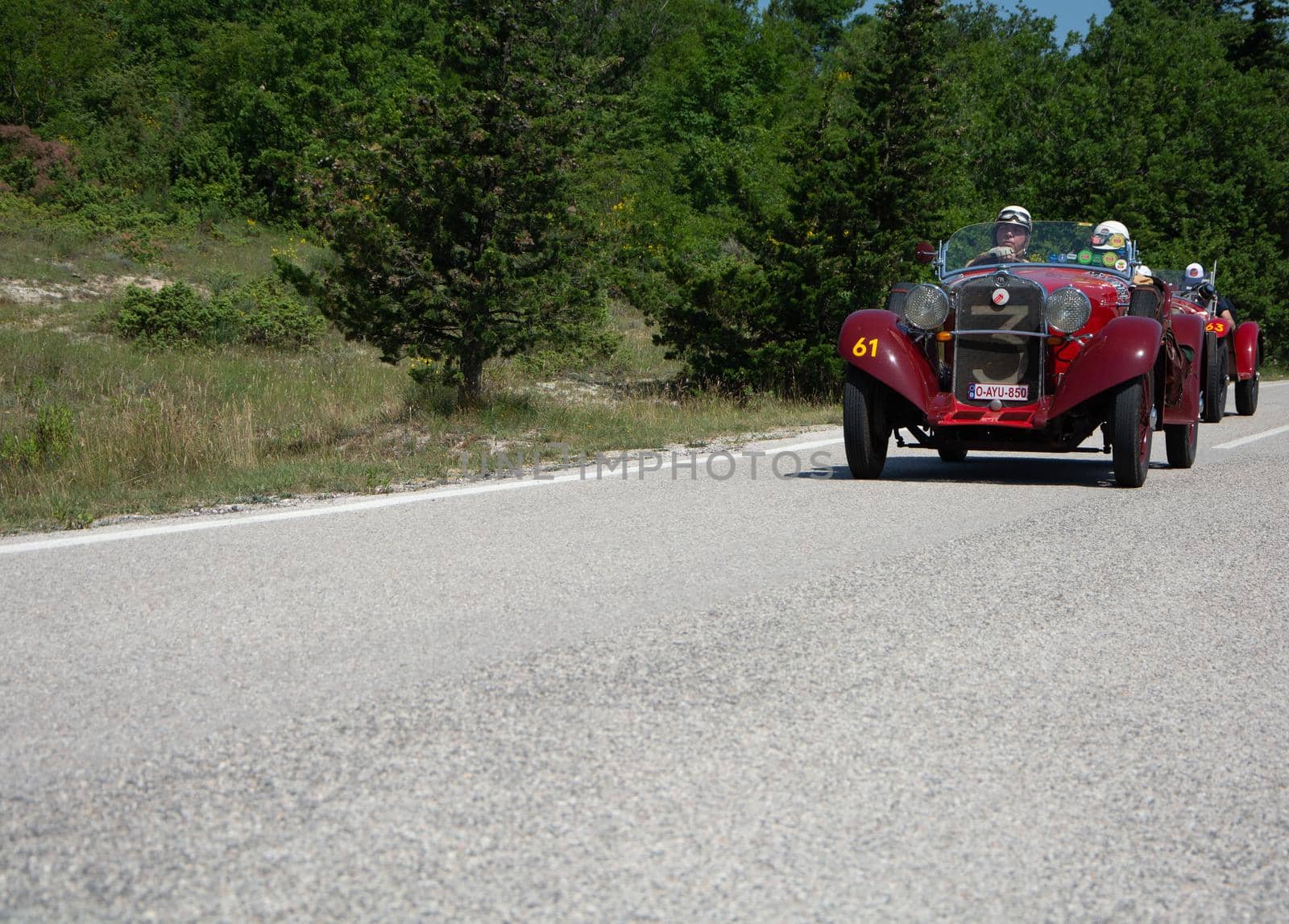 URBINO - ITALY - JUN 16 - 2022 : fiat on an old racing car in rally Mille Miglia 2022 the famous italian historical race (1927-1957