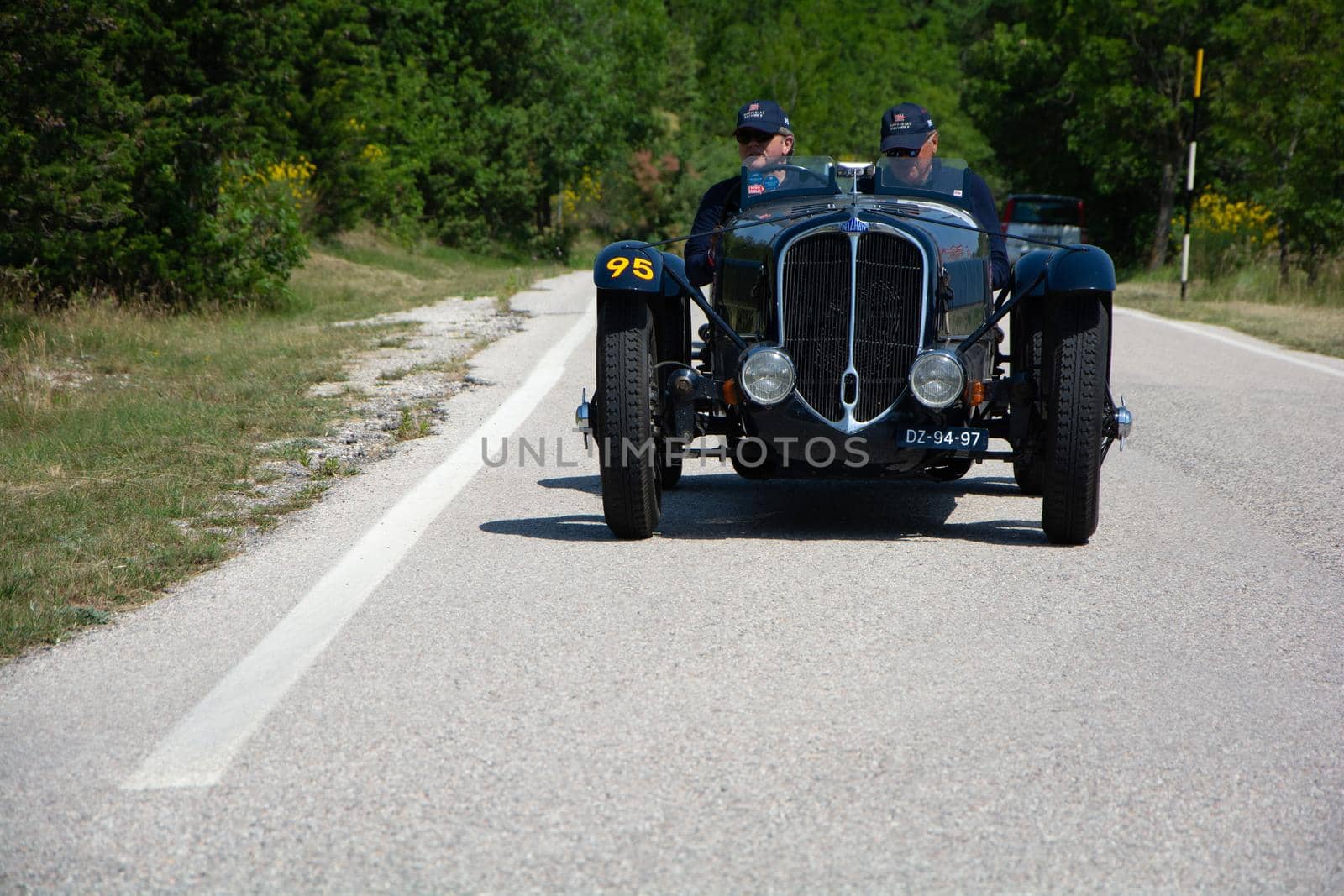 URBINO - ITALY - JUN 16 - 2022 : DELAHAYE 135 CS 1936 on an old racing car in rally Mille Miglia 2022 the famous italian historical race (1927-1957