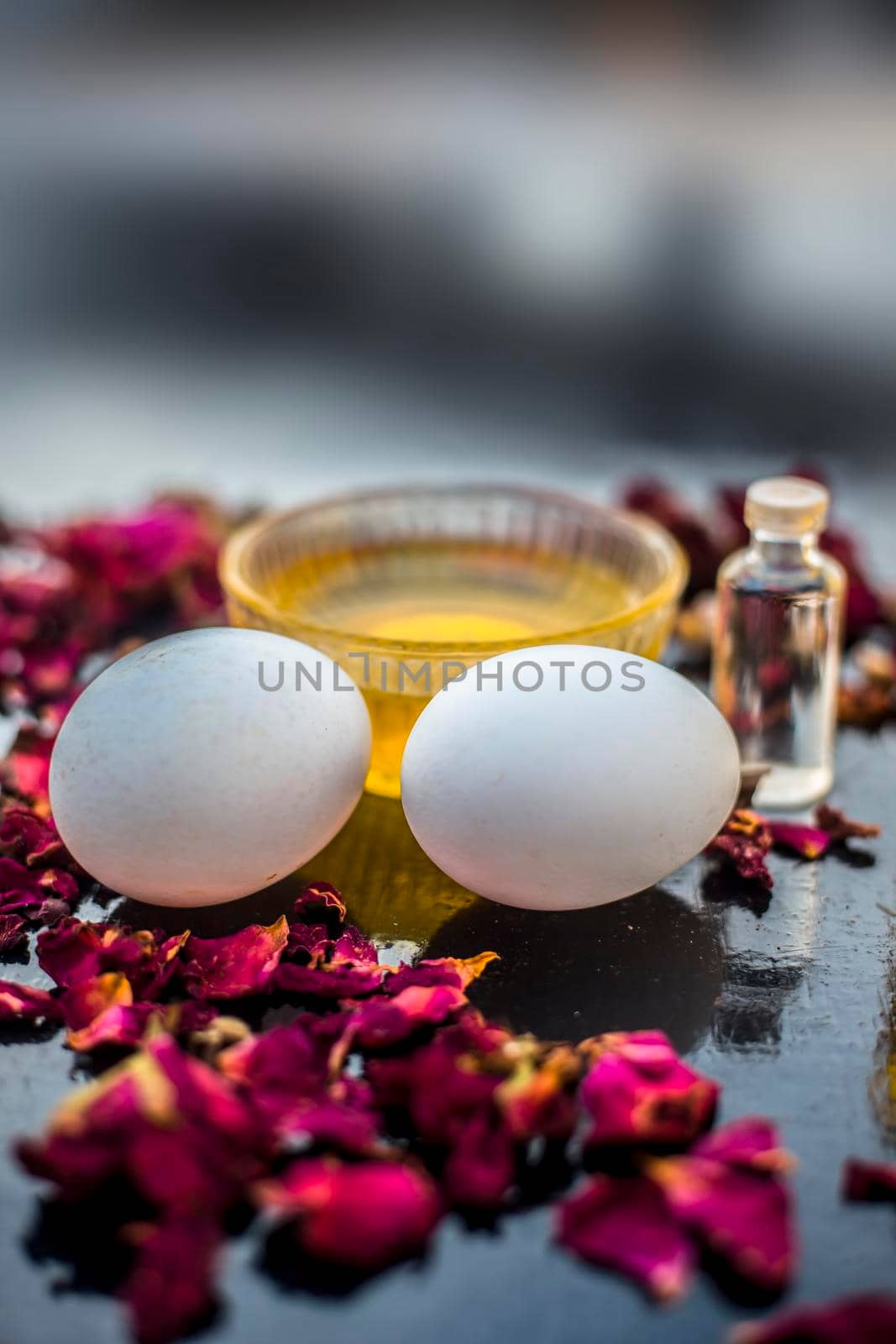 Trio pack of herbs and ingredients to fight dandruff on the wooden surface well mixed in a glass bowl which are castor oil, coconut oil, and egg. Also used to treat itchiness and to deep condition. by mirzamlk