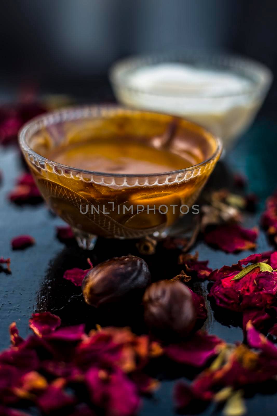 Nutmeg face mask to treat to even out discolorations and pigmentation on your face on the wooden surface consisting of Nutmeg powder, lemon juice, and curd.