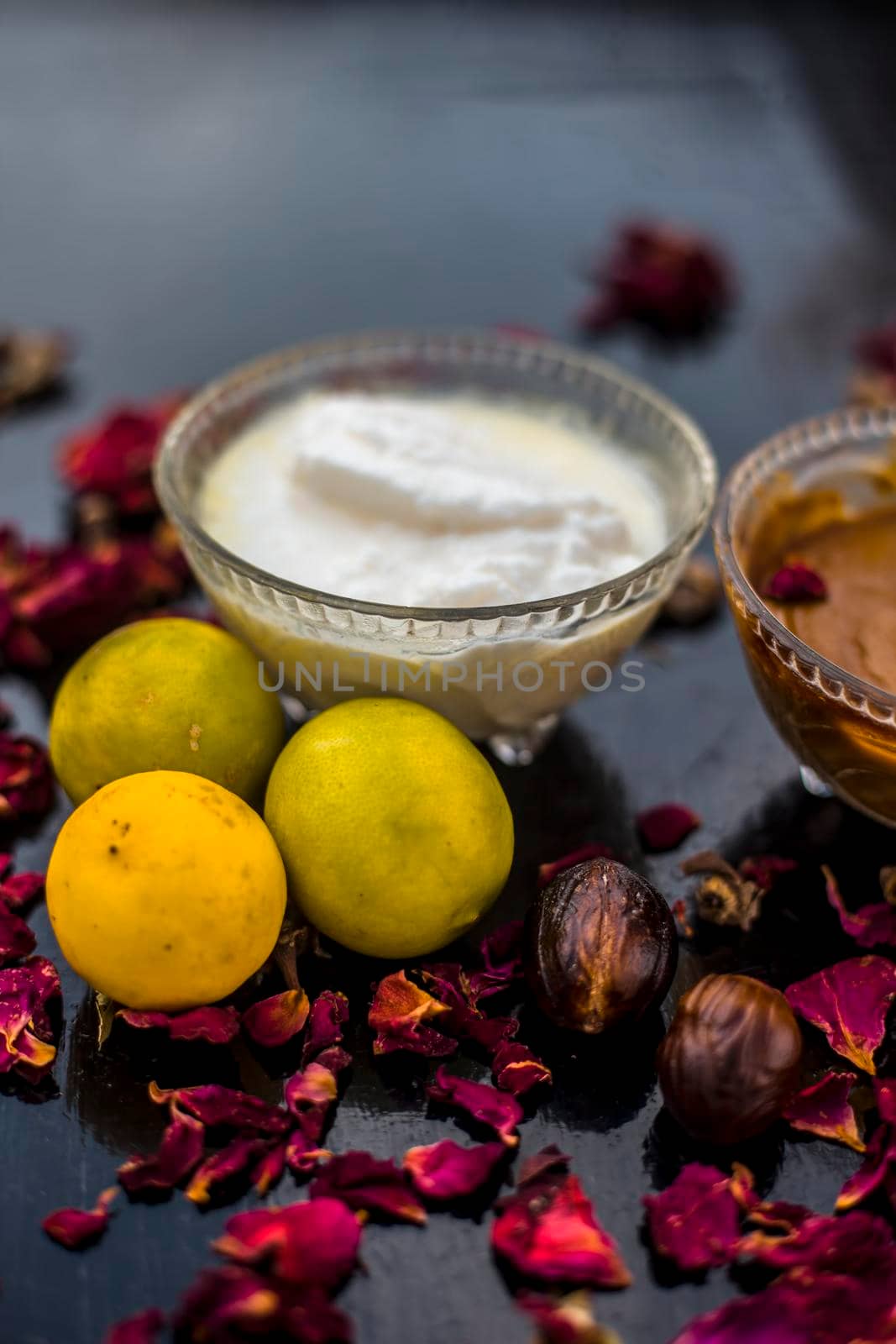 Nutmeg face mask to treat to even out discolorations and pigmentation on your face on the wooden surface consisting of Nutmeg powder, lemon juice, and curd. by mirzamlk