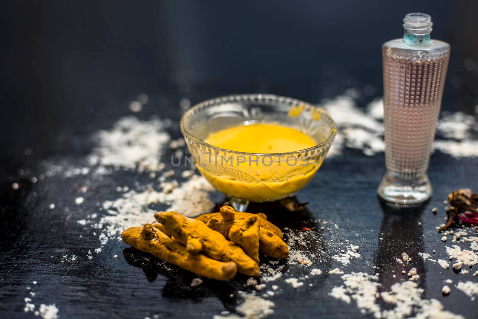 Gram flour or chickpea flour well mixed with turmeric using rose water in a glass bowl and making gram flour face mask for maintaining the pH of the skin.