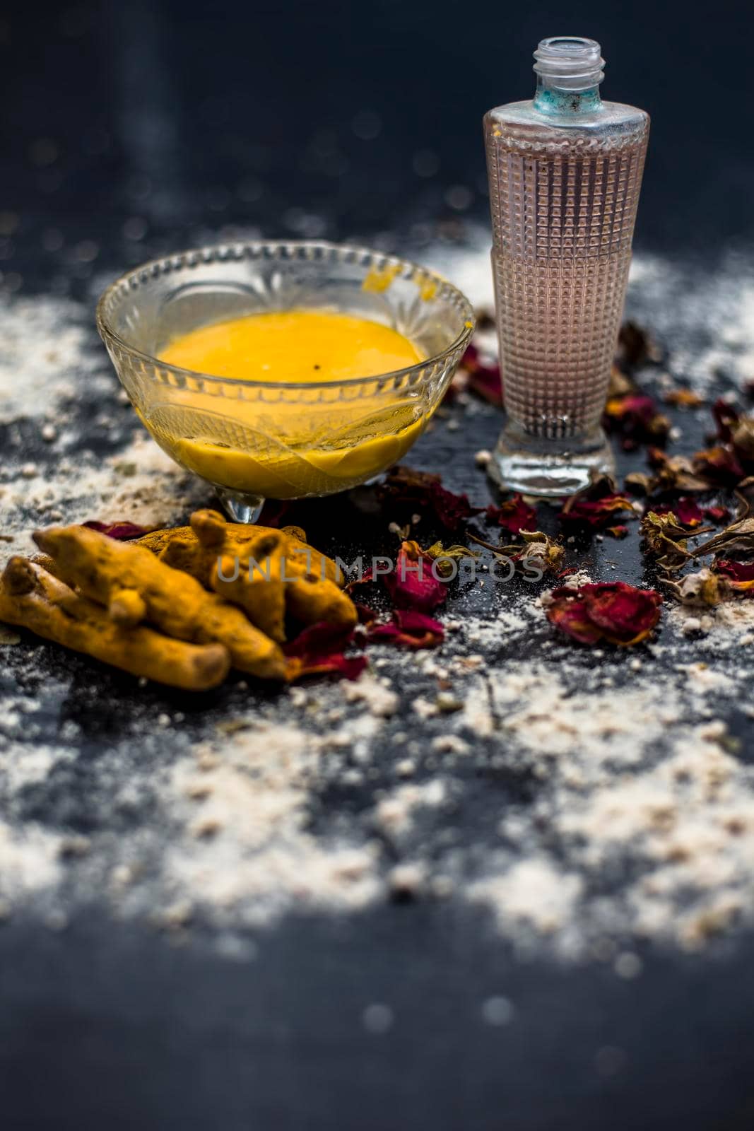 Gram flour or chickpea flour well mixed with turmeric using rose water in a glass bowl and making gram flour face mask for maintaining the pH of the skin. by mirzamlk