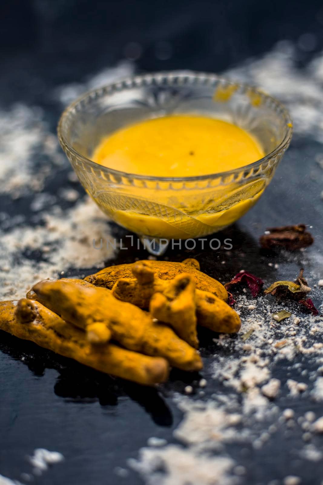 Gram flour or chickpea flour well mixed with turmeric using rose water in a glass bowl and making gram flour face mask for maintaining the pH of the skin. by mirzamlk