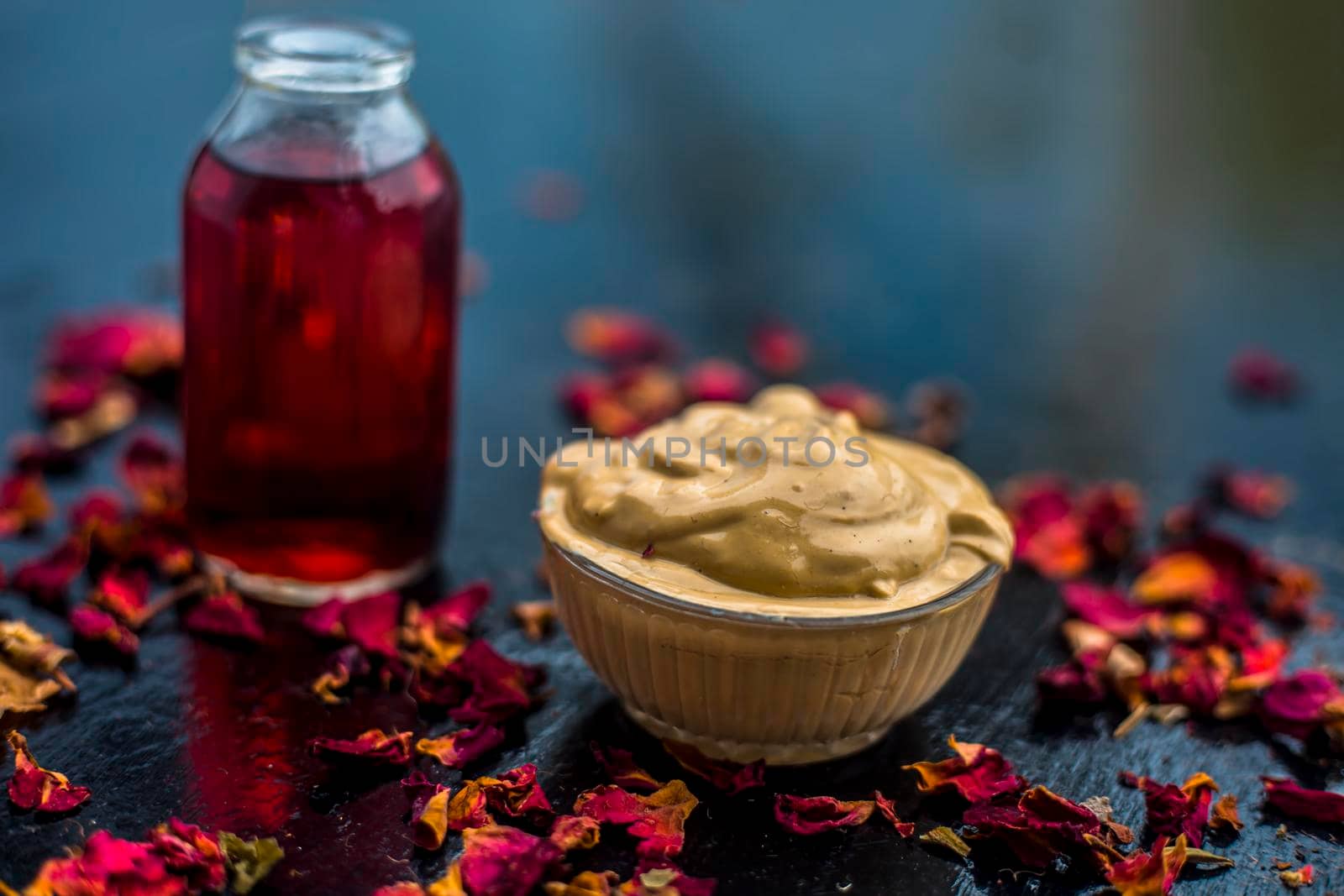 Ubtan/face mask/face pack of Multani mitti or fuller's earth on wooden surface in a glass bowl consisting of Multani mitti and rose water for the remedy or treatment of oily skin.On wooden surface. by mirzamlk