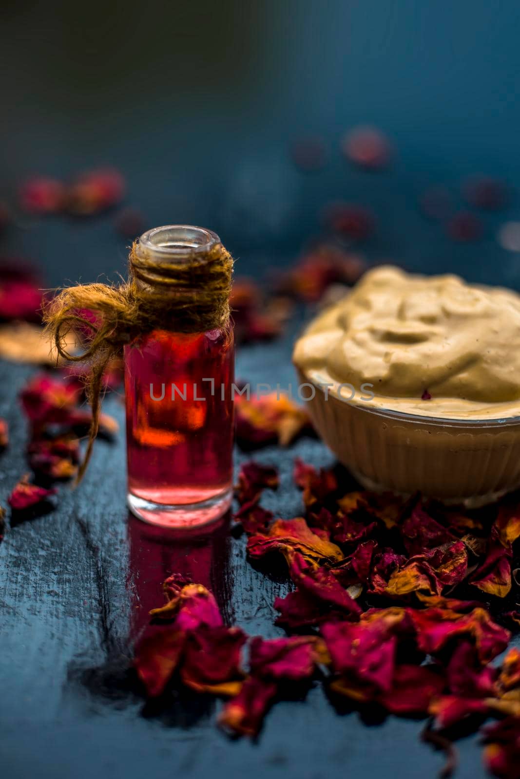 Ubtan/face mask/face pack of Multani mitti or fuller's earth on wooden surface in a glass bowl consisting of Multani mitti and rose water for the remedy or treatment of oily skin.On wooden surface. by mirzamlk