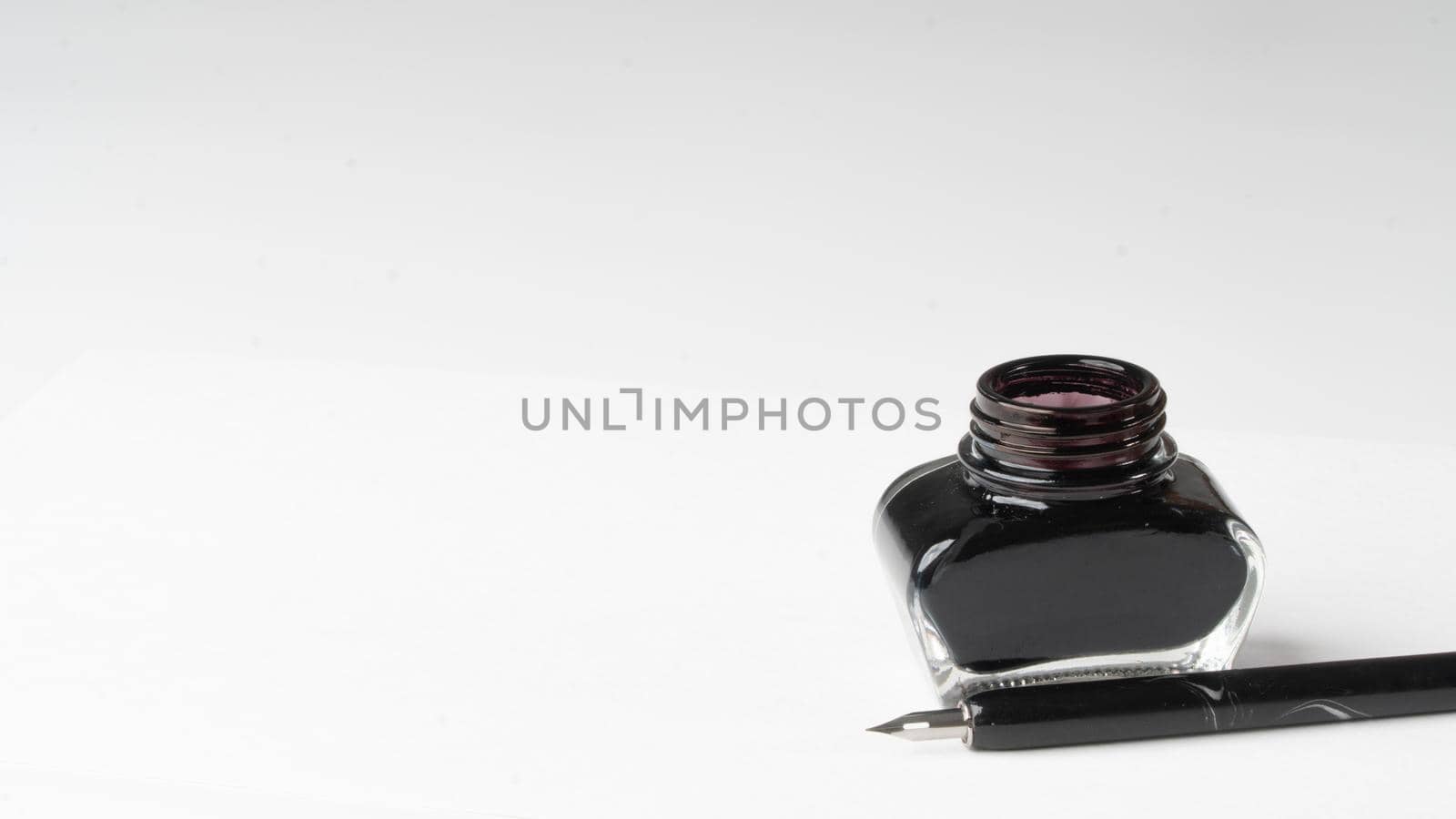 Inkwell and pen on a white background space for inscription by voktybre