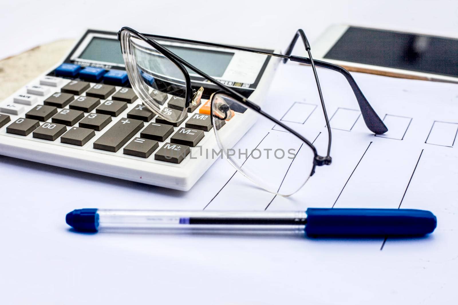 Close up of workplace of businessman or finance consultant isolated on white using credit card, cell phone, pen and calculator like things. by mirzamlk